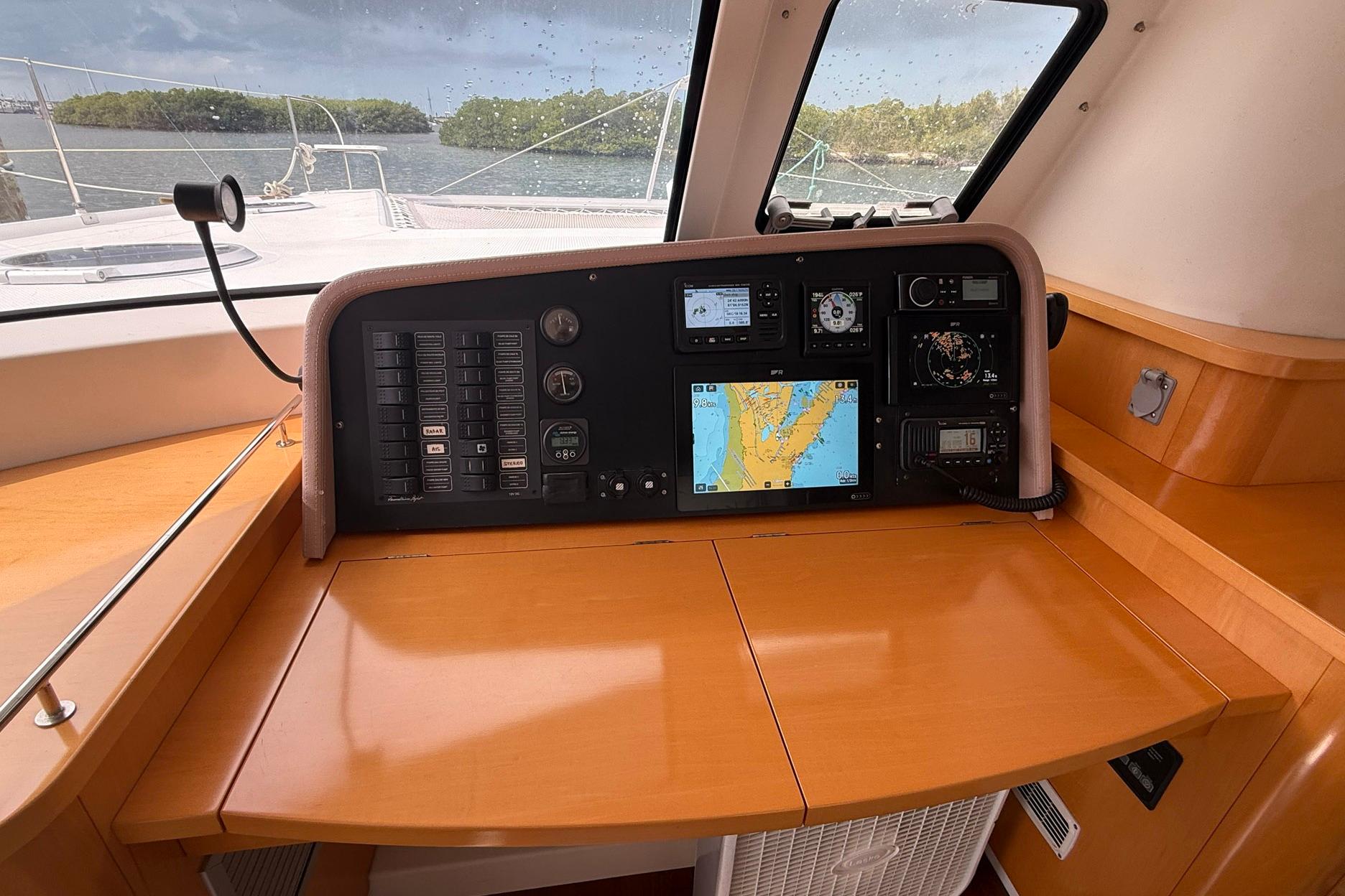 Navigation station of 2008 Fountaine Pajot Salina 48 catamaran with control panels and map display.