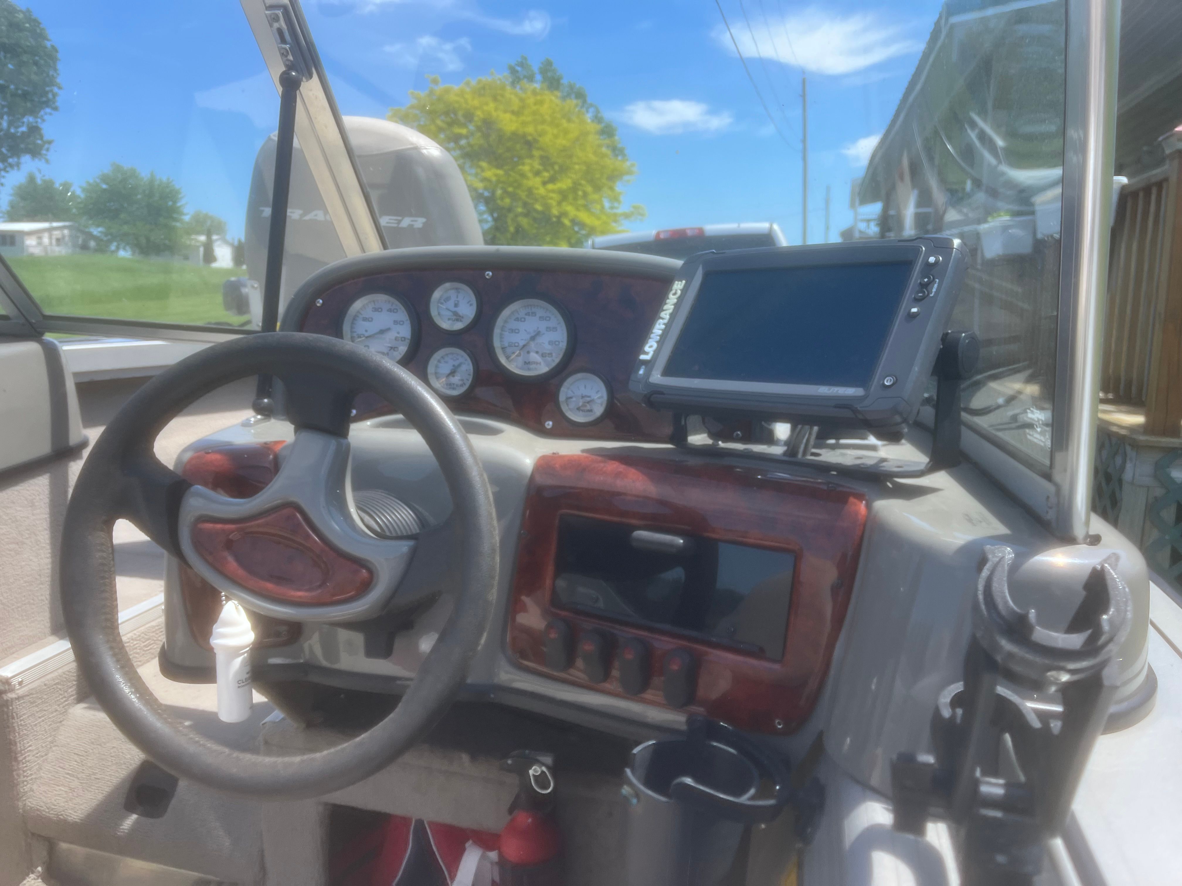The cockpit of a 2004 Tracker Targa 18 WT with steering wheel and instrument panel.