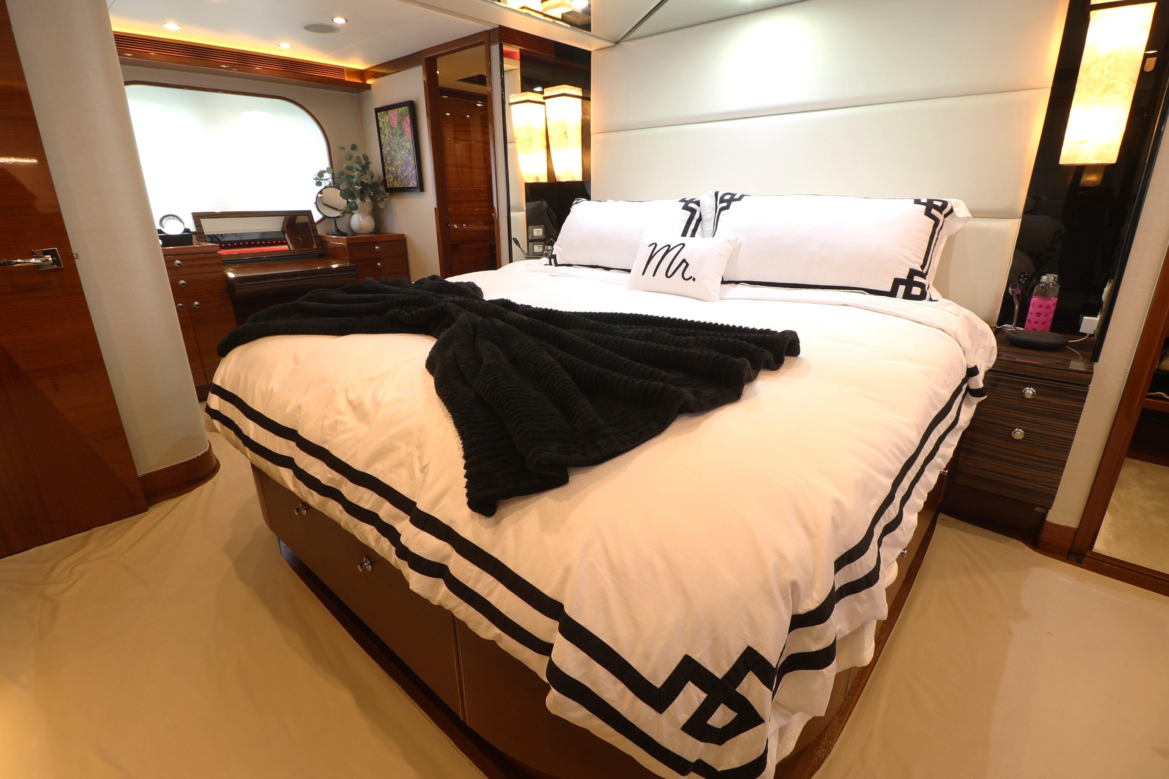 Luxurious bedroom interior of 2013 Cheoy Lee Bravo yacht with elegant bedding and decor.