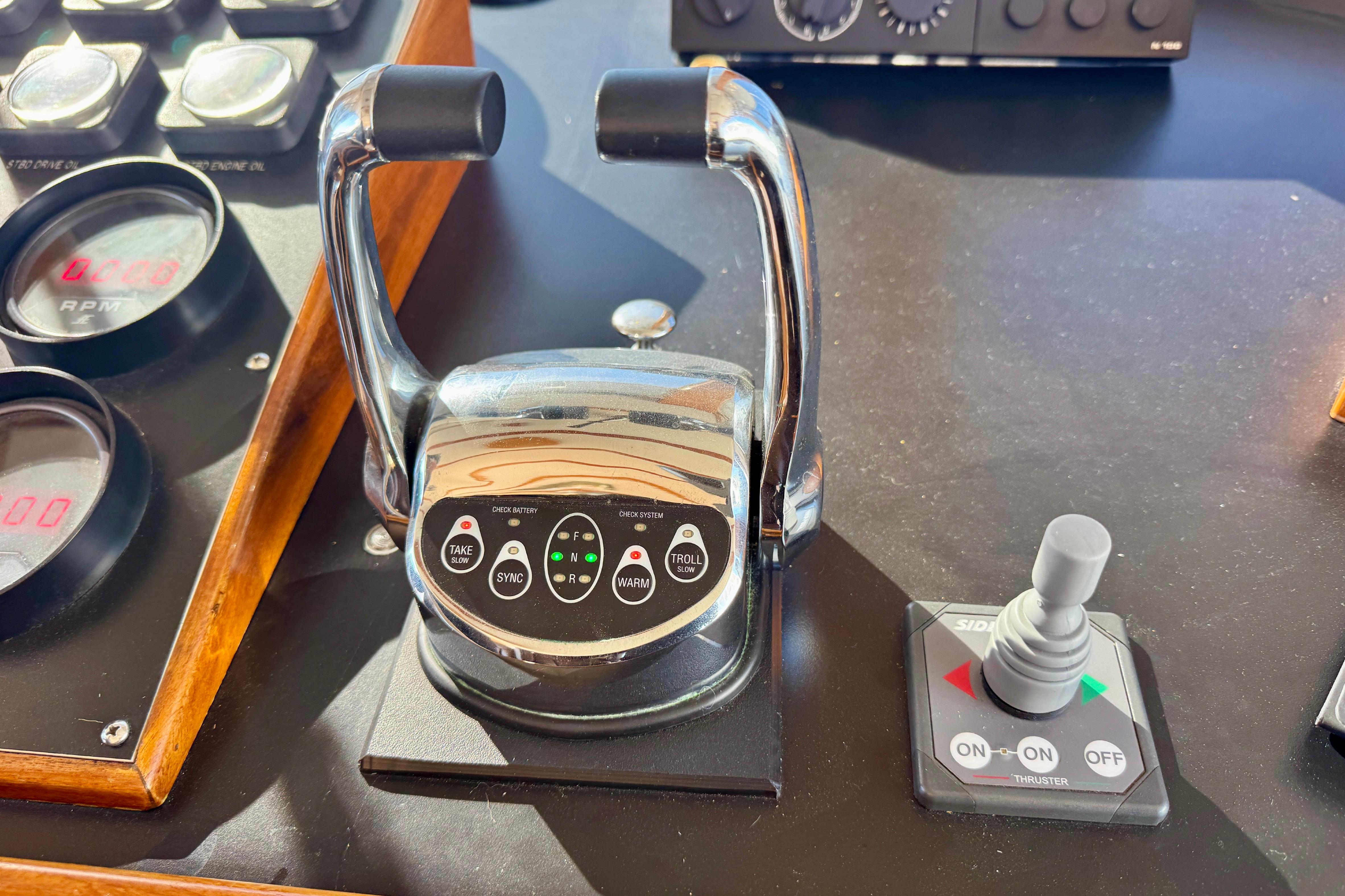 1958 Blanchard Pilothouse controls with throttle levers and joystick on dashboard.