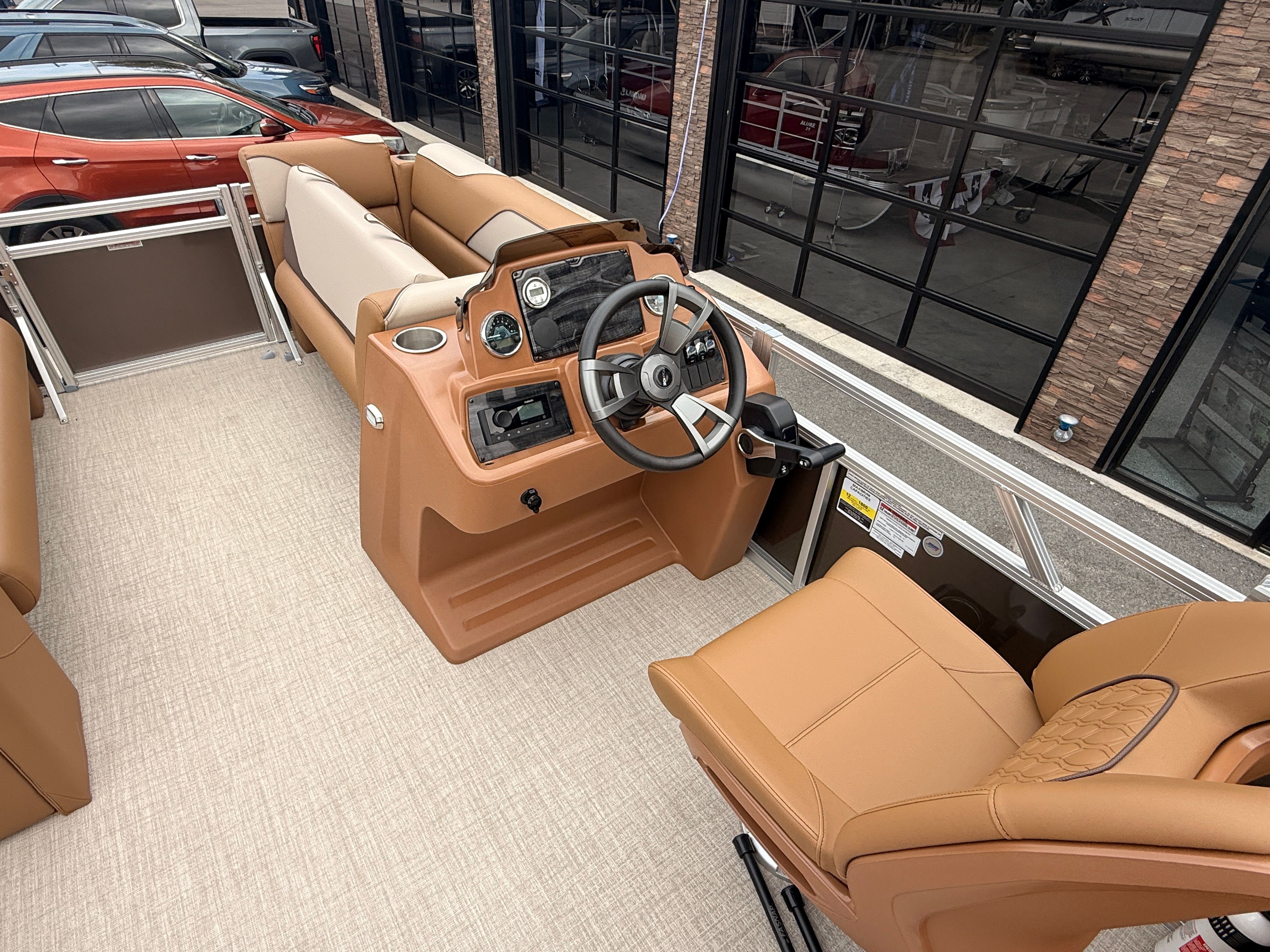 Interior of 2026 Tahoe 2380 Sport Quad Lounger with steering wheel and seats.
