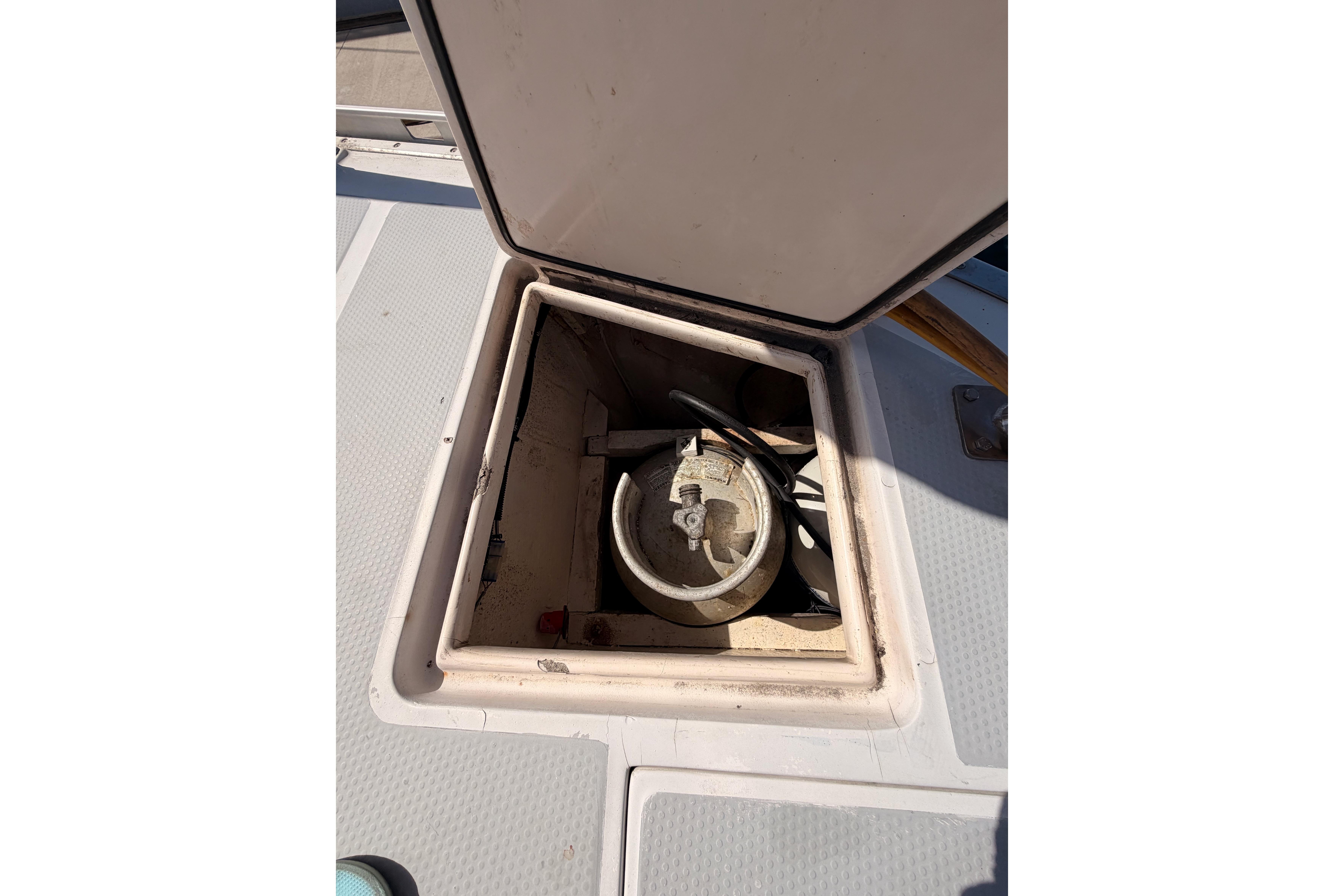 Open hatch on 1991 Hylas 51 sailboat deck, revealing storage compartment.
