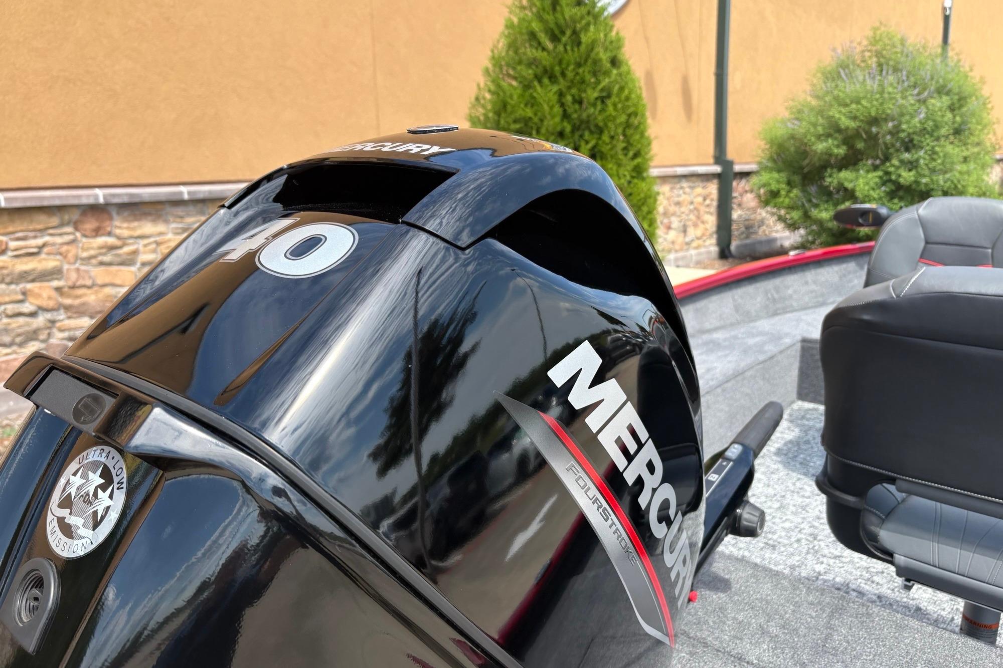 2026 Tracker Super Guide V-16 T with Mercury outboard motor, parked outdoors.