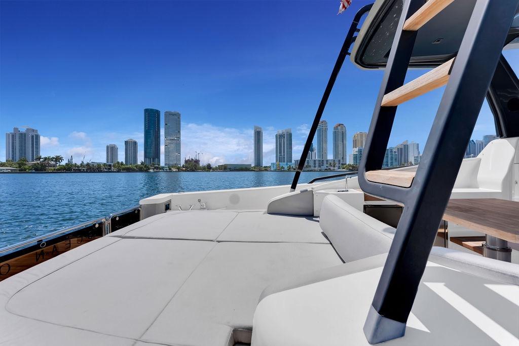 2021 Bluegame BG 42 yacht with city skyline and ocean view.