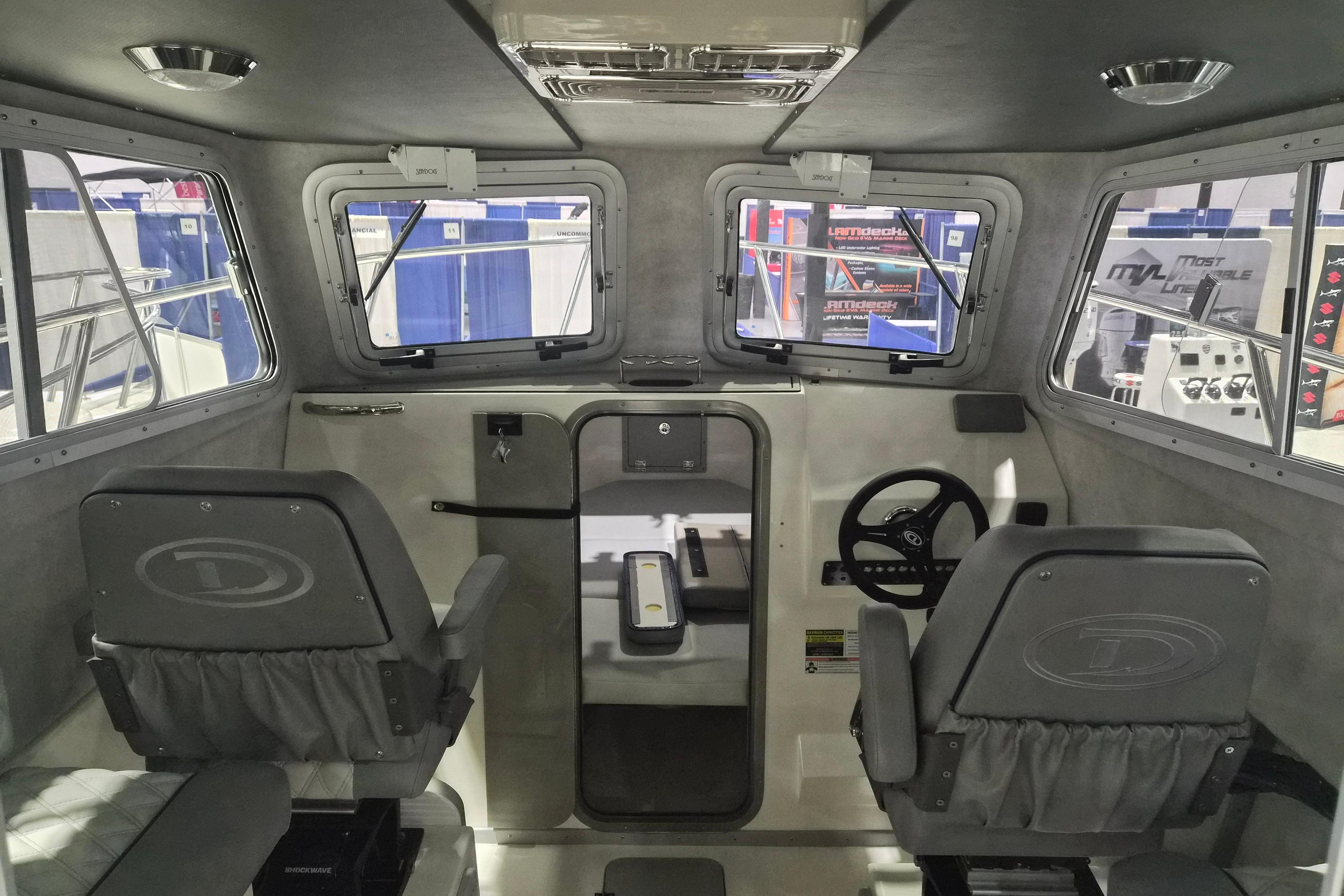 Interior of 2026 Defiance Admiral 260 EX boat, featuring dual seats and control panel.