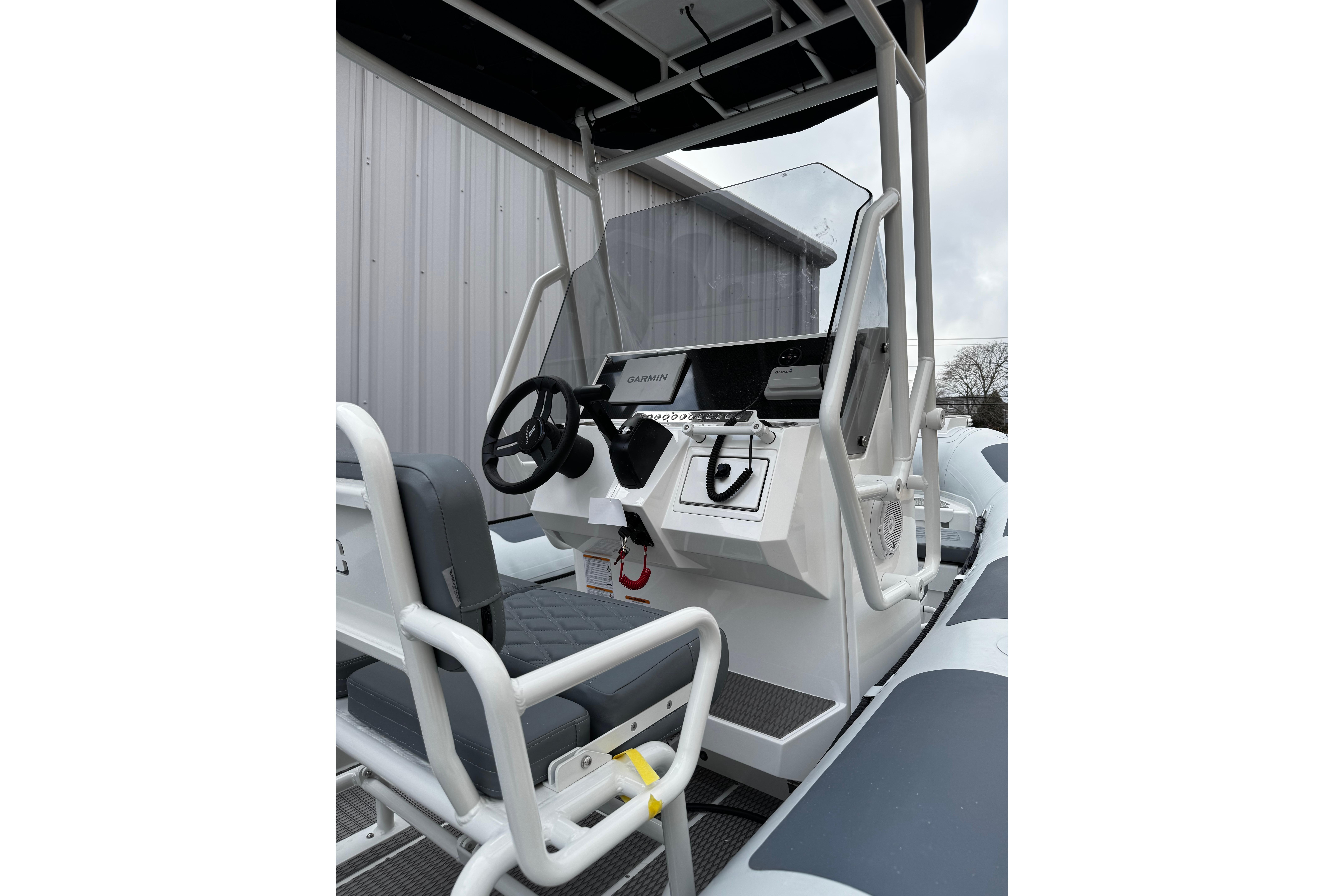 2026 Highfield Patrol 600 boat console with steering wheel and navigation equipment.