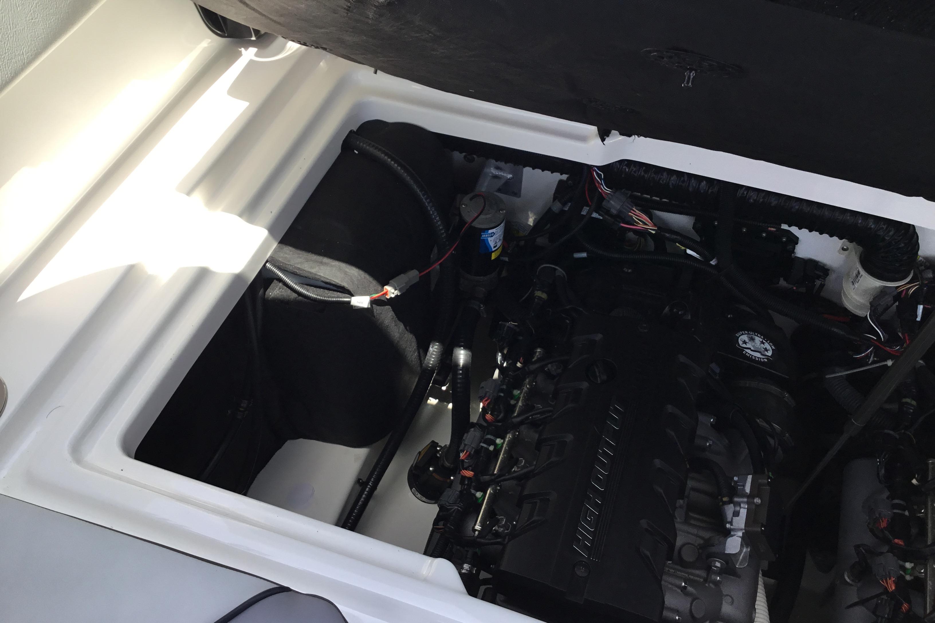 Engine compartment of 2023 Yamaha Boats 252XE, showcasing internal components and wiring.