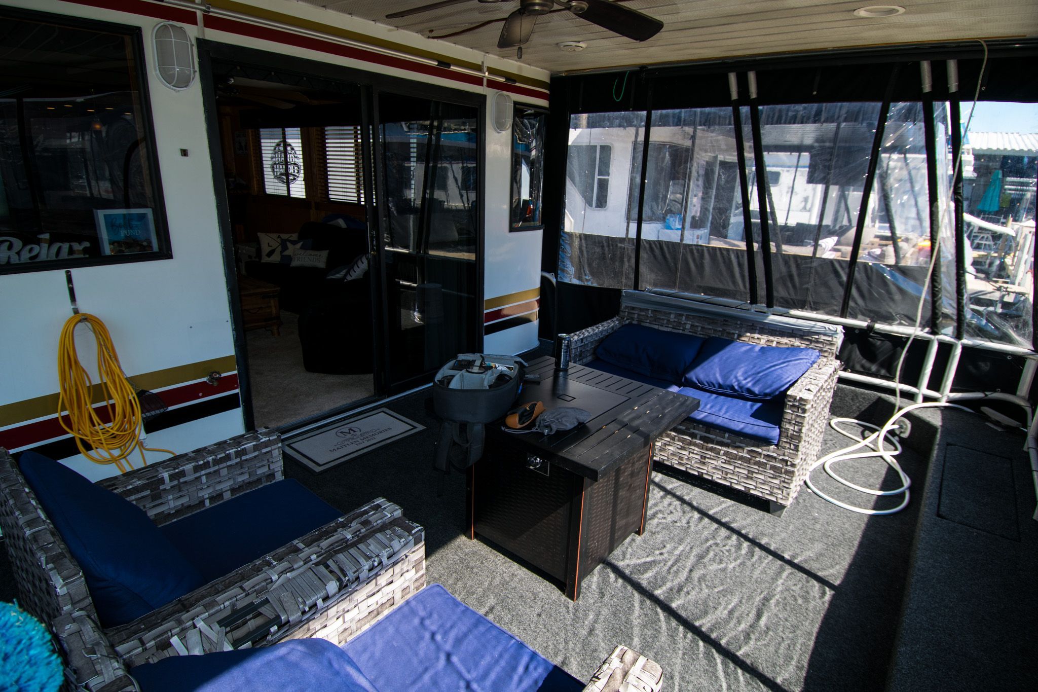 2003 Lakeview 16x70 houseboat with cozy outdoor seating area.