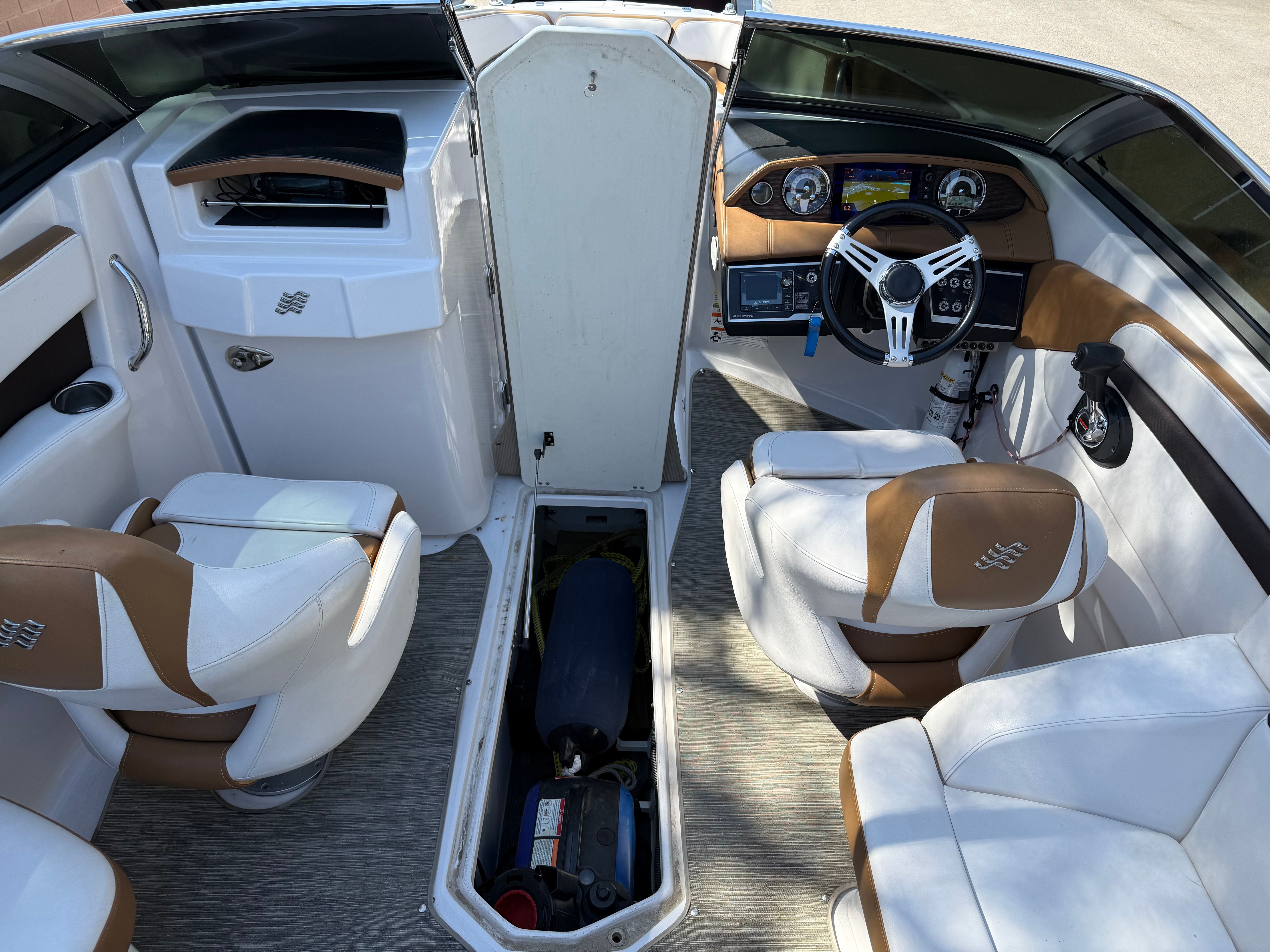 Interior of a 2019 Four Winns H260 boat with steering console.