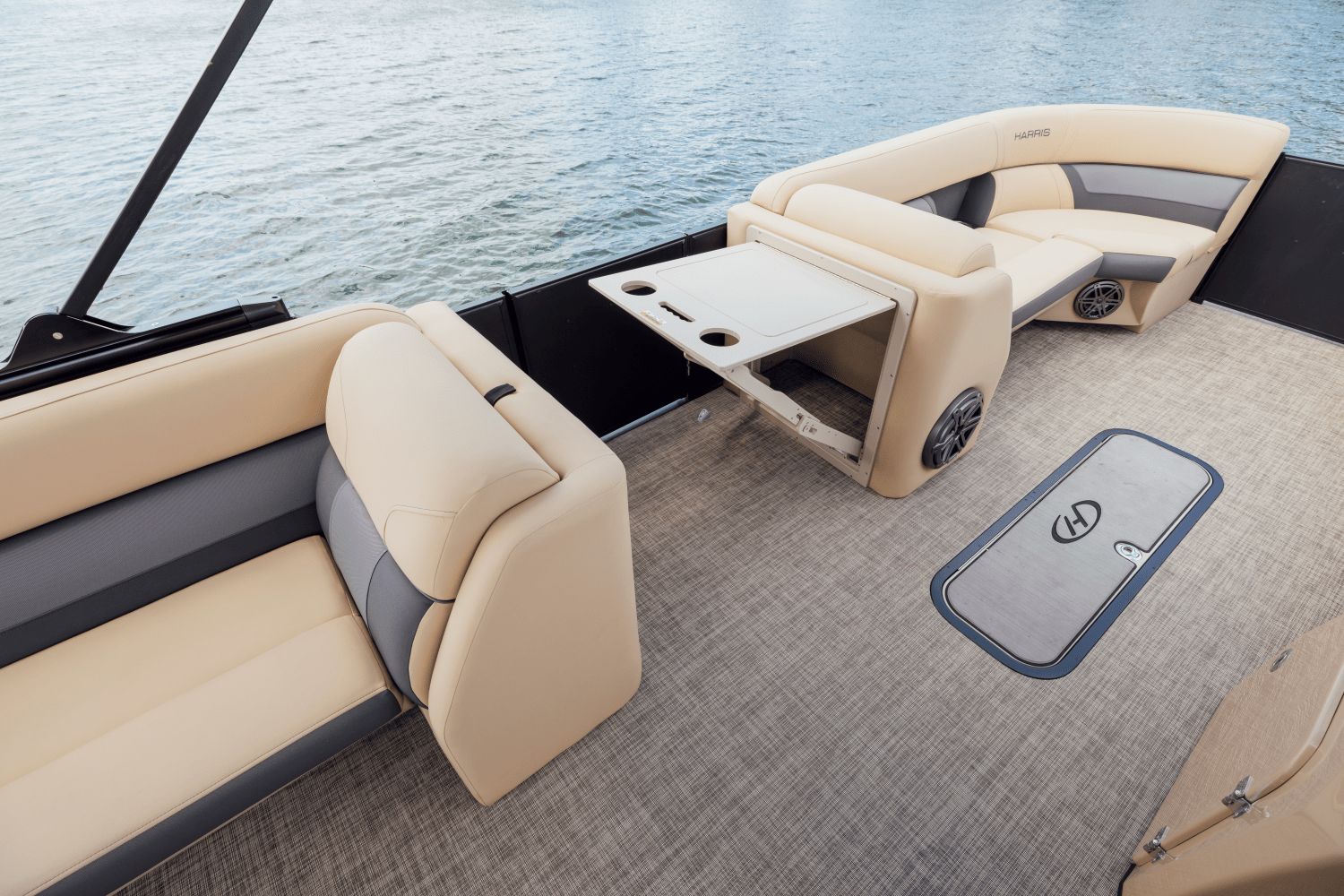 The image shows the interior of a 2026 Harris Cruiser 230 boat with beige seating.