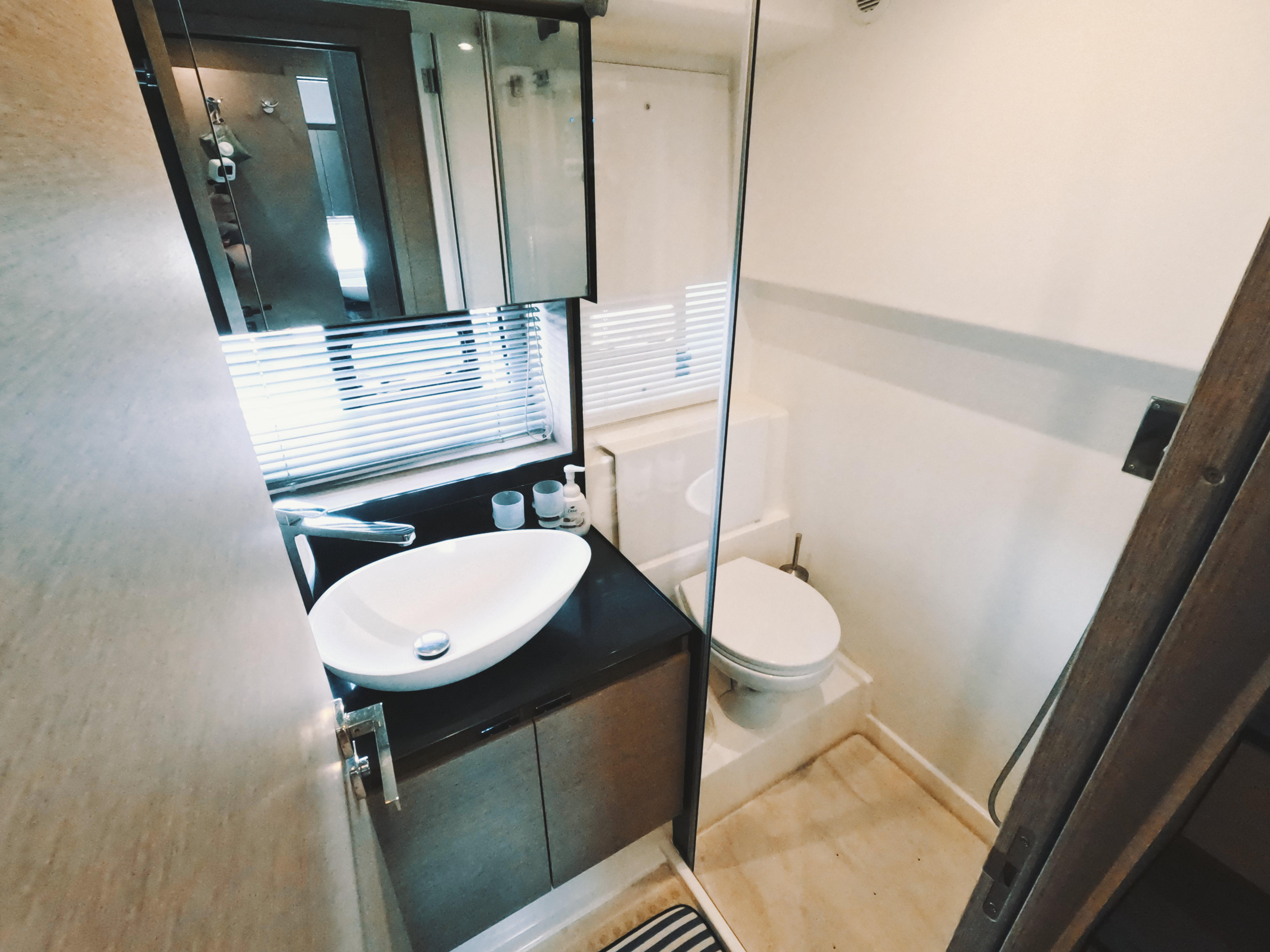 Modern bathroom in 2020 Prestige 460 yacht with sleek sink and toilet.