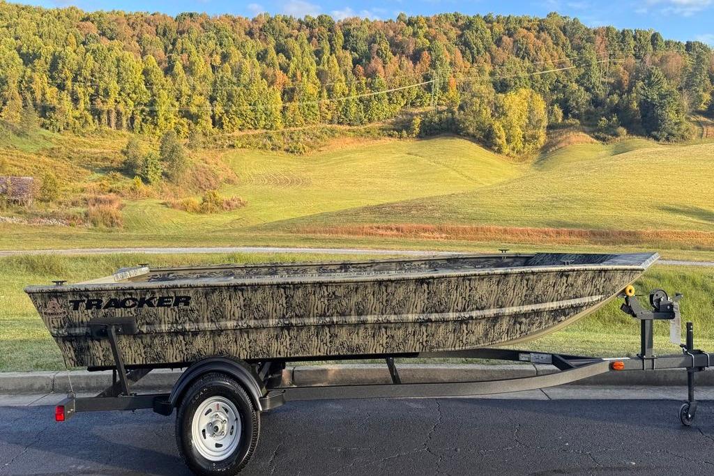2026 Tracker Grizzly 1754 Utility boat on trailer, scenic countryside background.