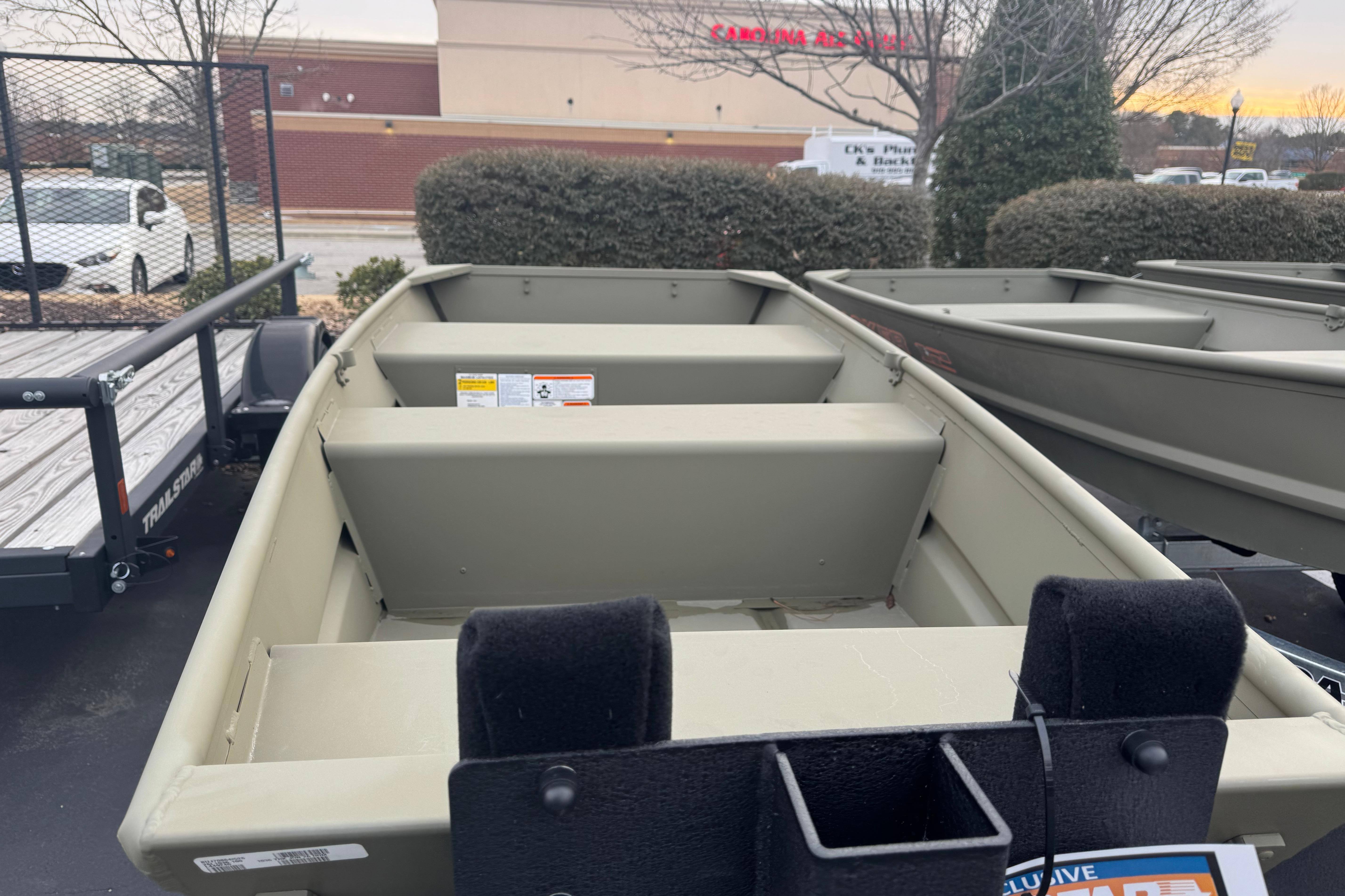 2026 Tracker Grizzly 10 Jon boat displayed outdoors, showcasing its interior seating and design.