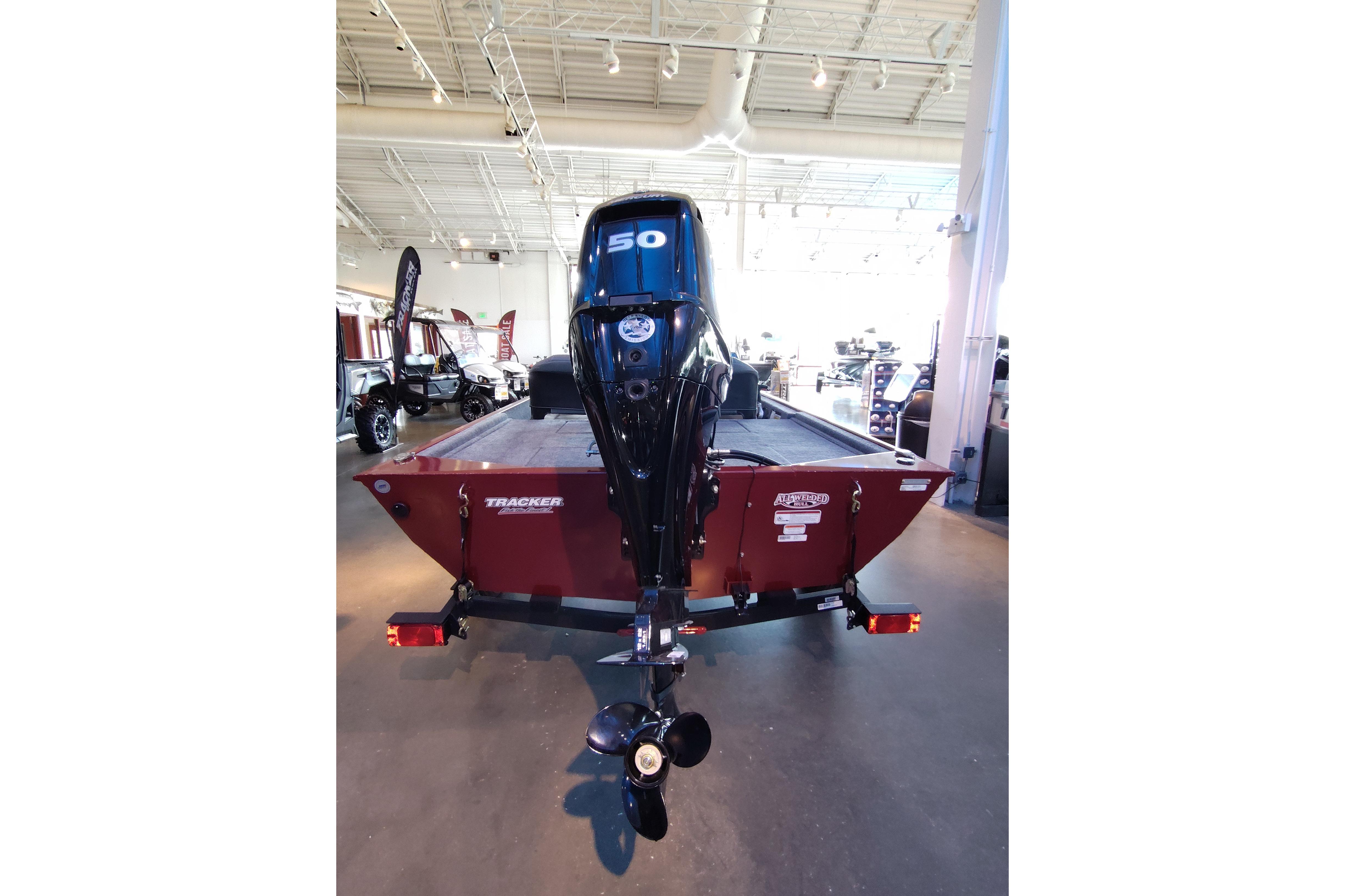 2026 Tracker Bass Tracker Classic XL boat displayed in a showroom, rear view with motor.