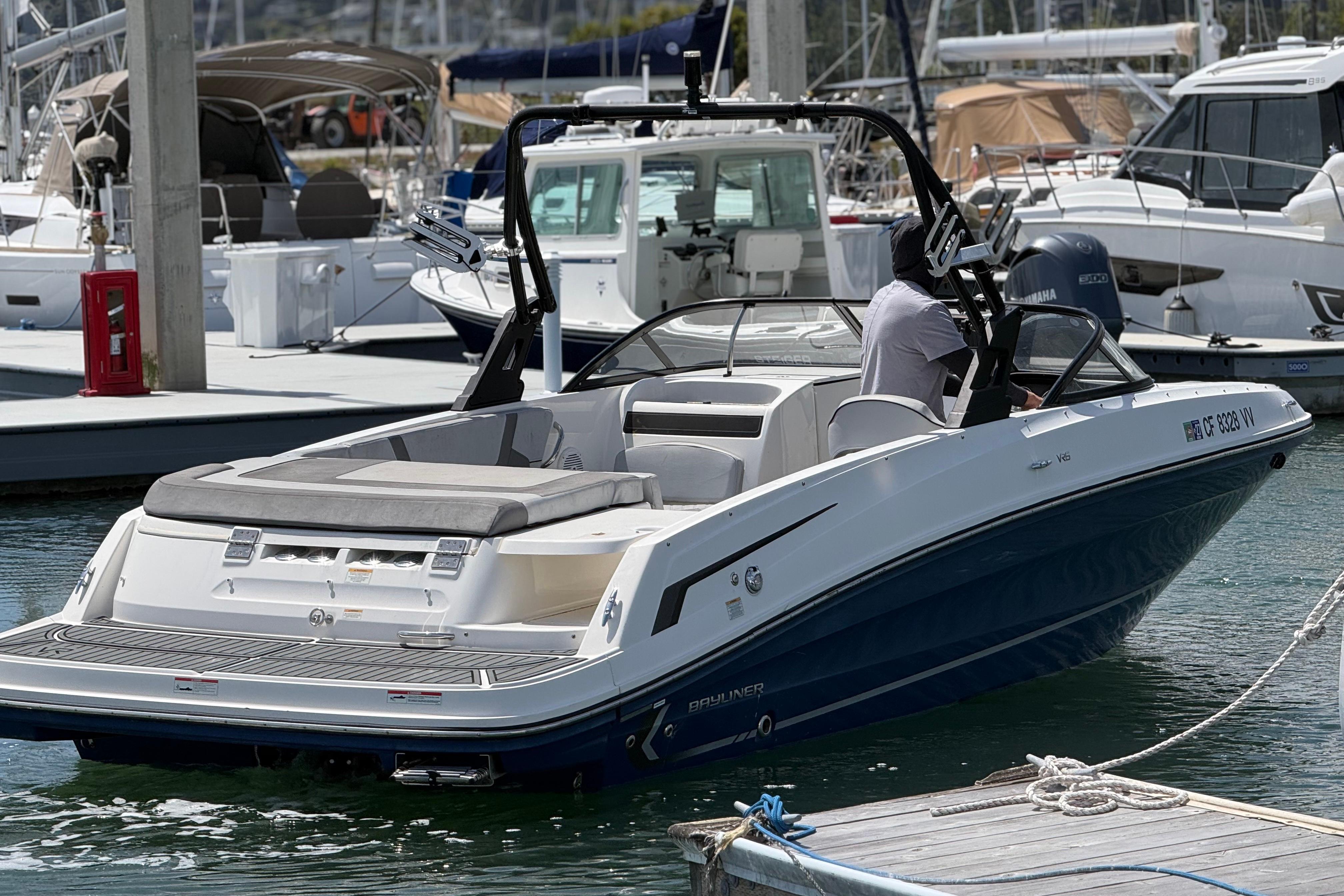 2021 Bayliner VR5 Bowrider I/O docked at marina, featuring sleek design and spacious seating.