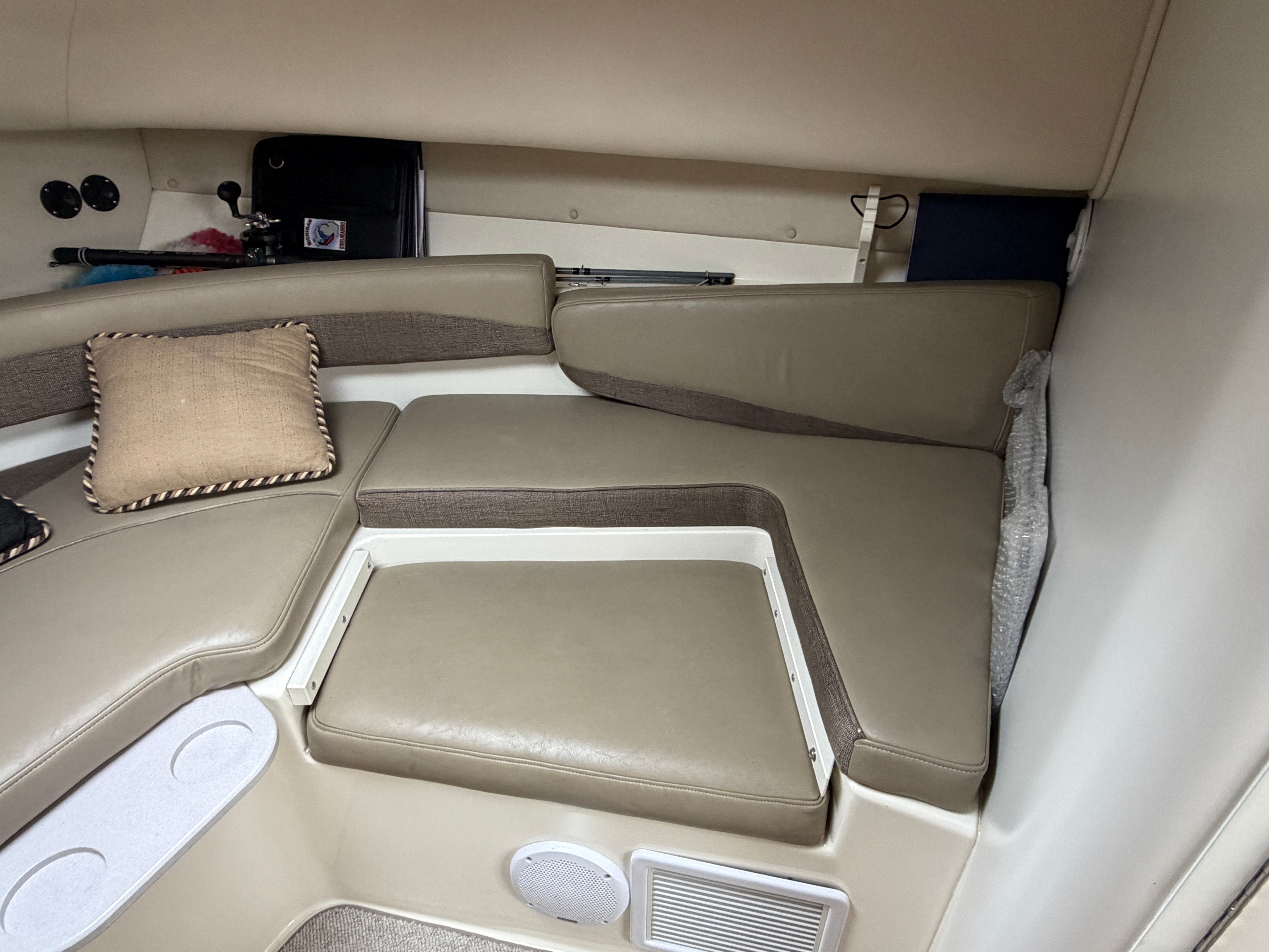 Interior of a 2001 Boston Whaler 26 Conquest with cushioned seating and pillows.