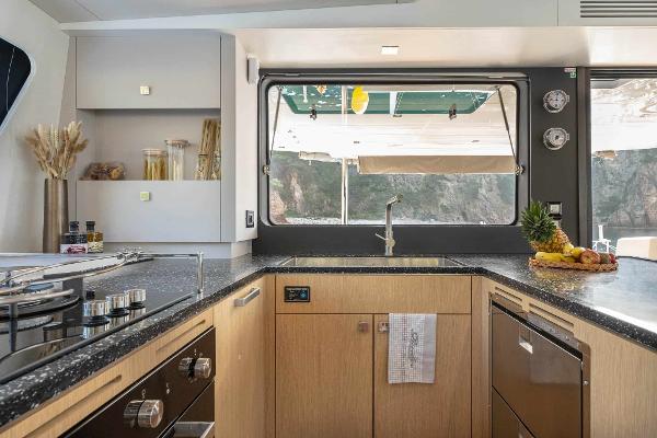 Modern kitchen interior on 2025 Privilege Signature 580 yacht, featuring sleek design and ocean view.