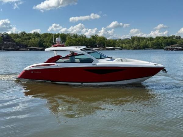 2022 Cobalt A36BR boat on a calm lake under a partly cloudy sky.