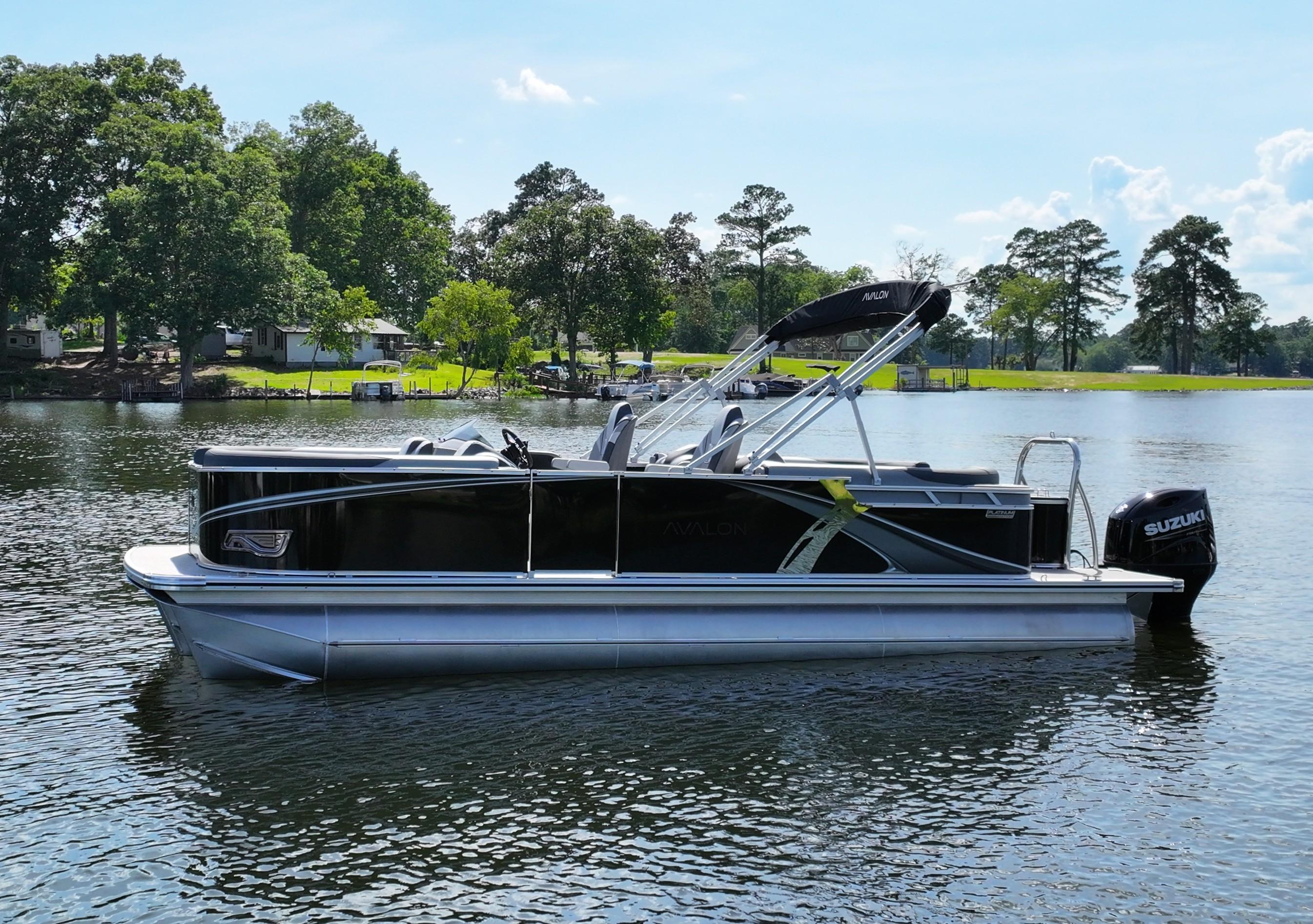 2025 Avalon LSZ Quad Lounger pontoon boat on a serene lake.