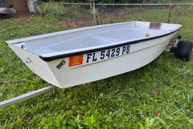 1999 Beacon Boats Pram on grass with Florida registration, trailer attached.