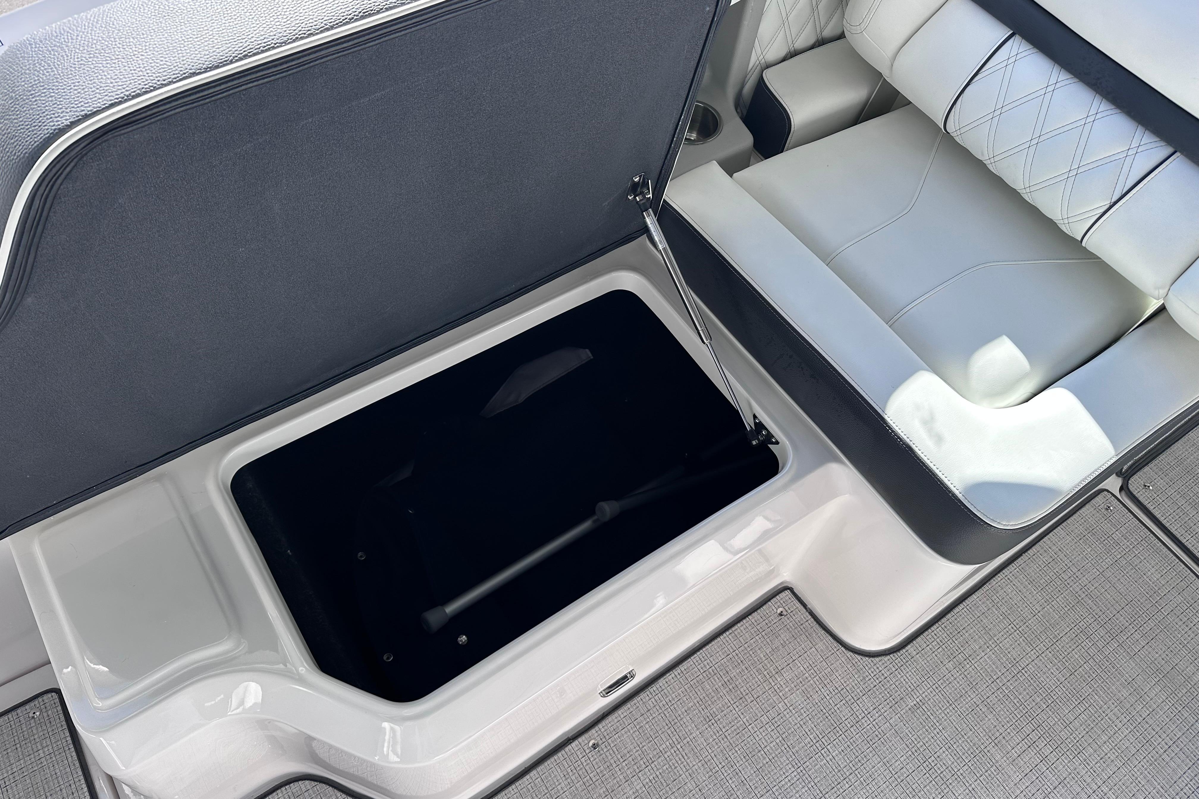 2026 Regal LX4 boat interior with open storage compartment and cushioned seating.