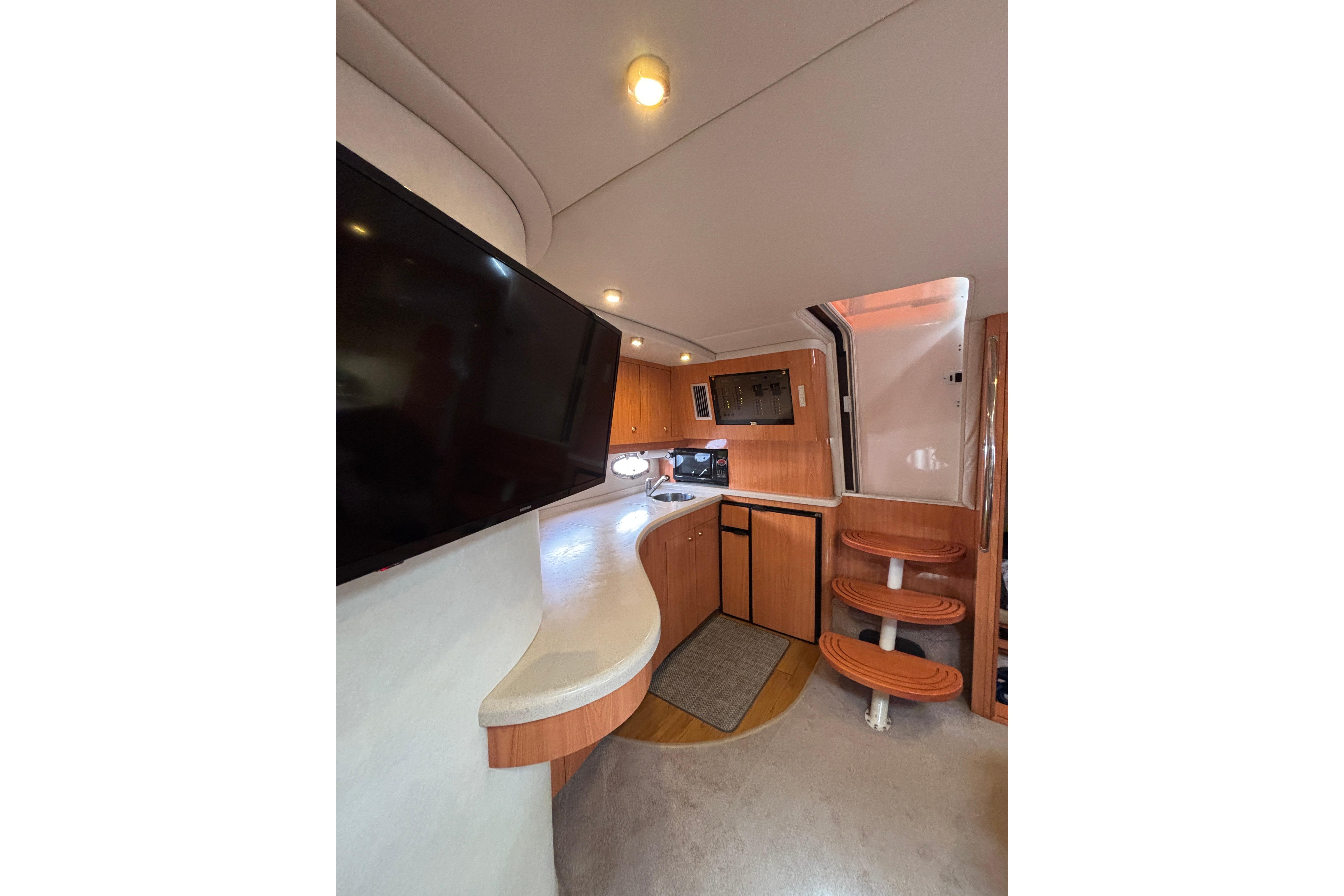 Interior of 2000 Regal Commodore 4160 yacht with modern amenities and wooden finishes.