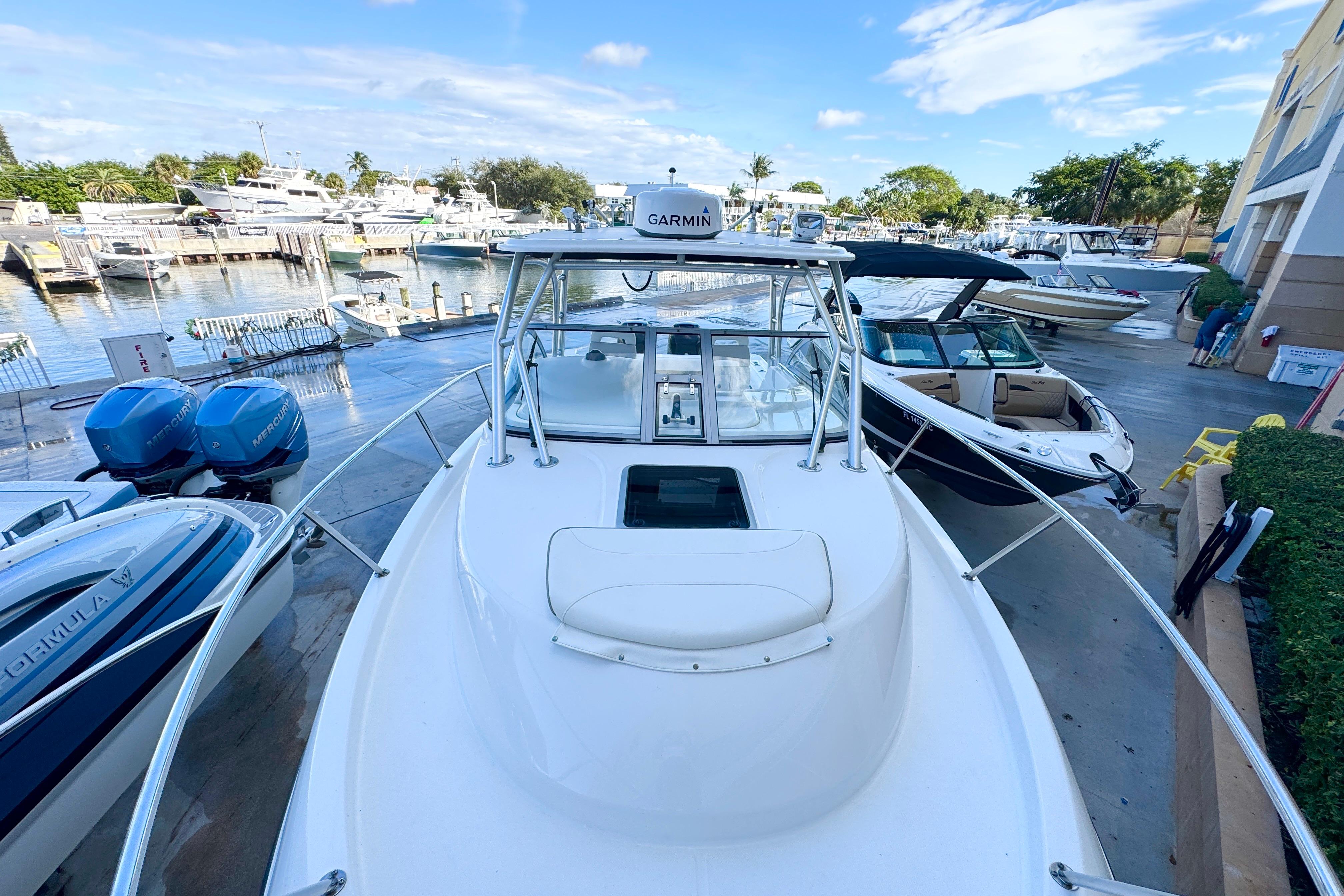 2006 Boston Whaler 285 Conquest boat docked at marina with clear sky.