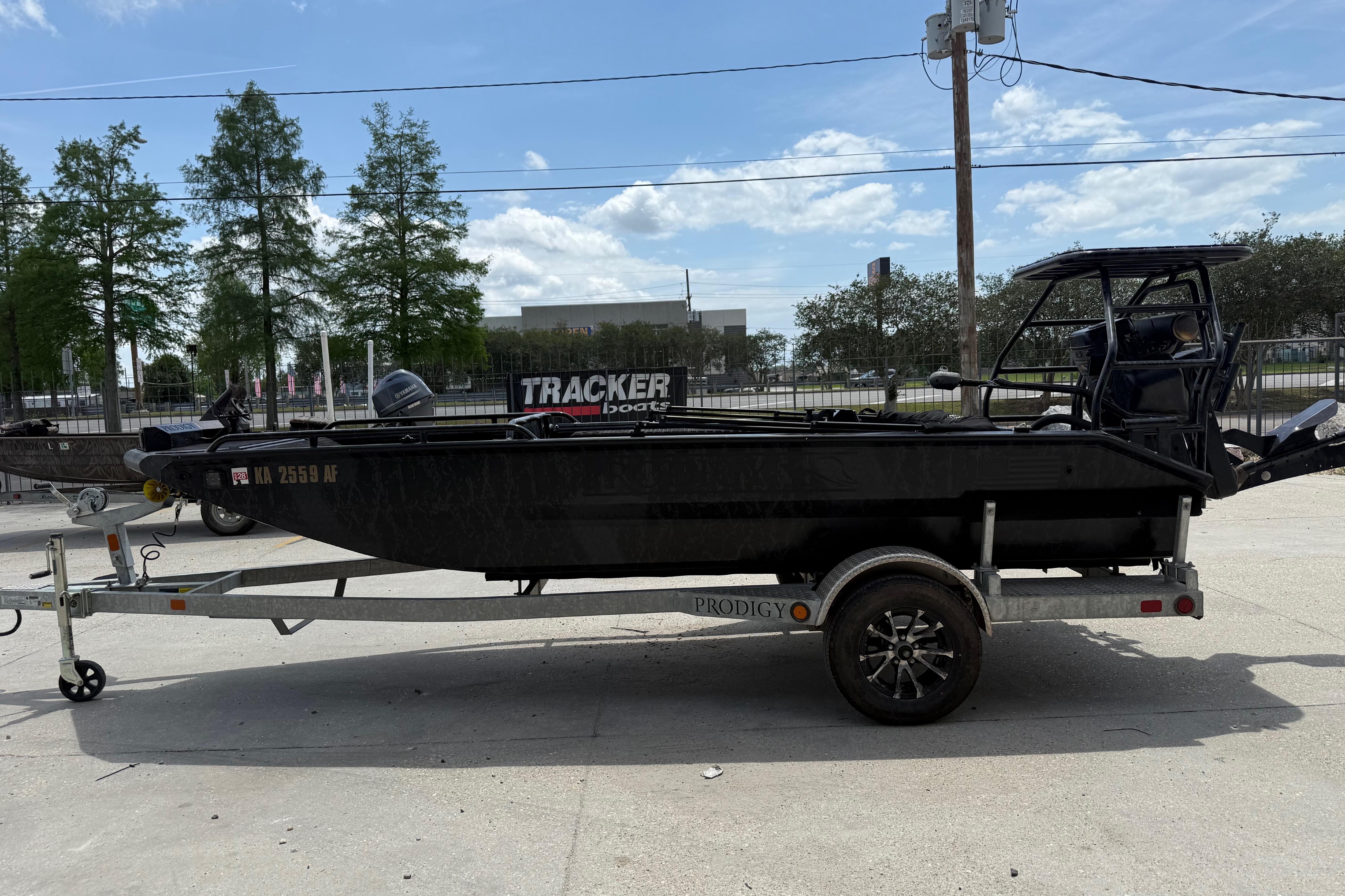2024 Prodigy 17 boat on trailer, parked outdoors under a clear sky.