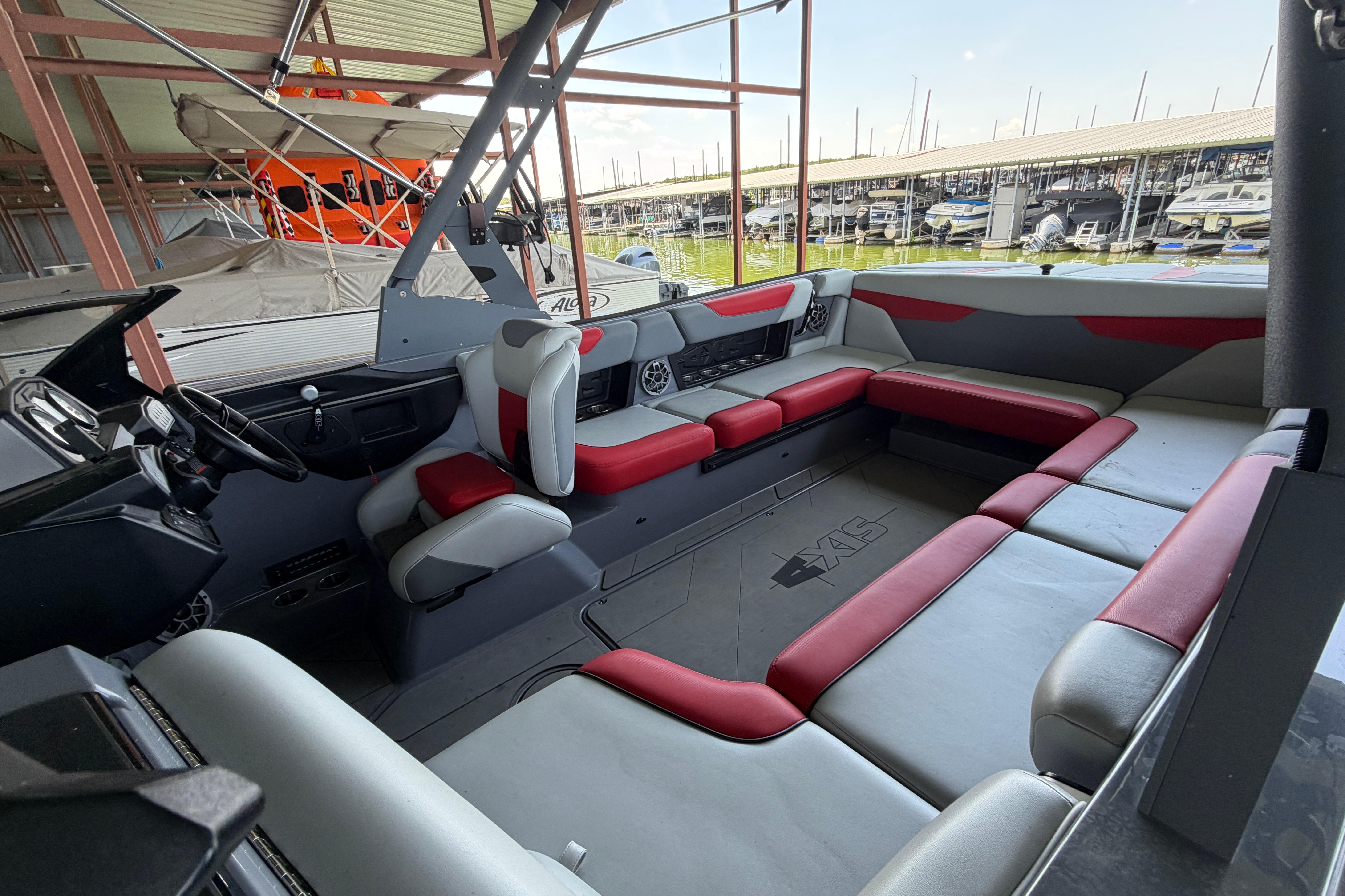 Interior of a 2021 Axis A24 boat with red and gray seating.