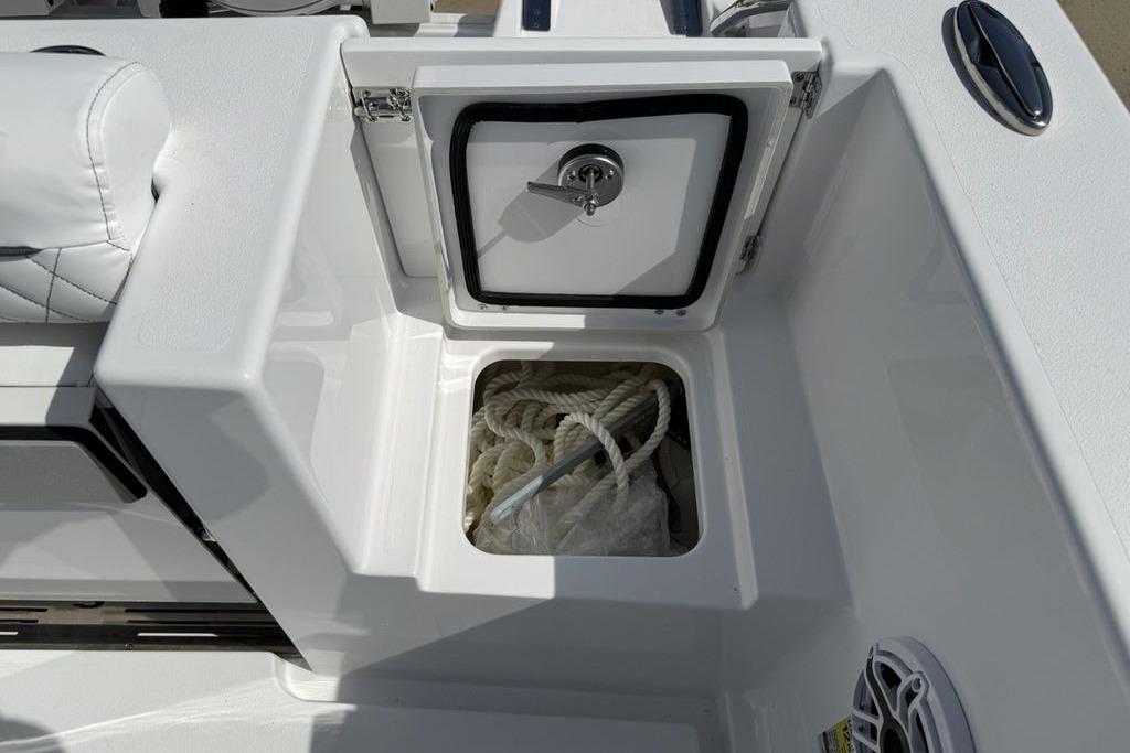 2026 Sportsman Open 252 Center Console boat storage compartment with rope inside.