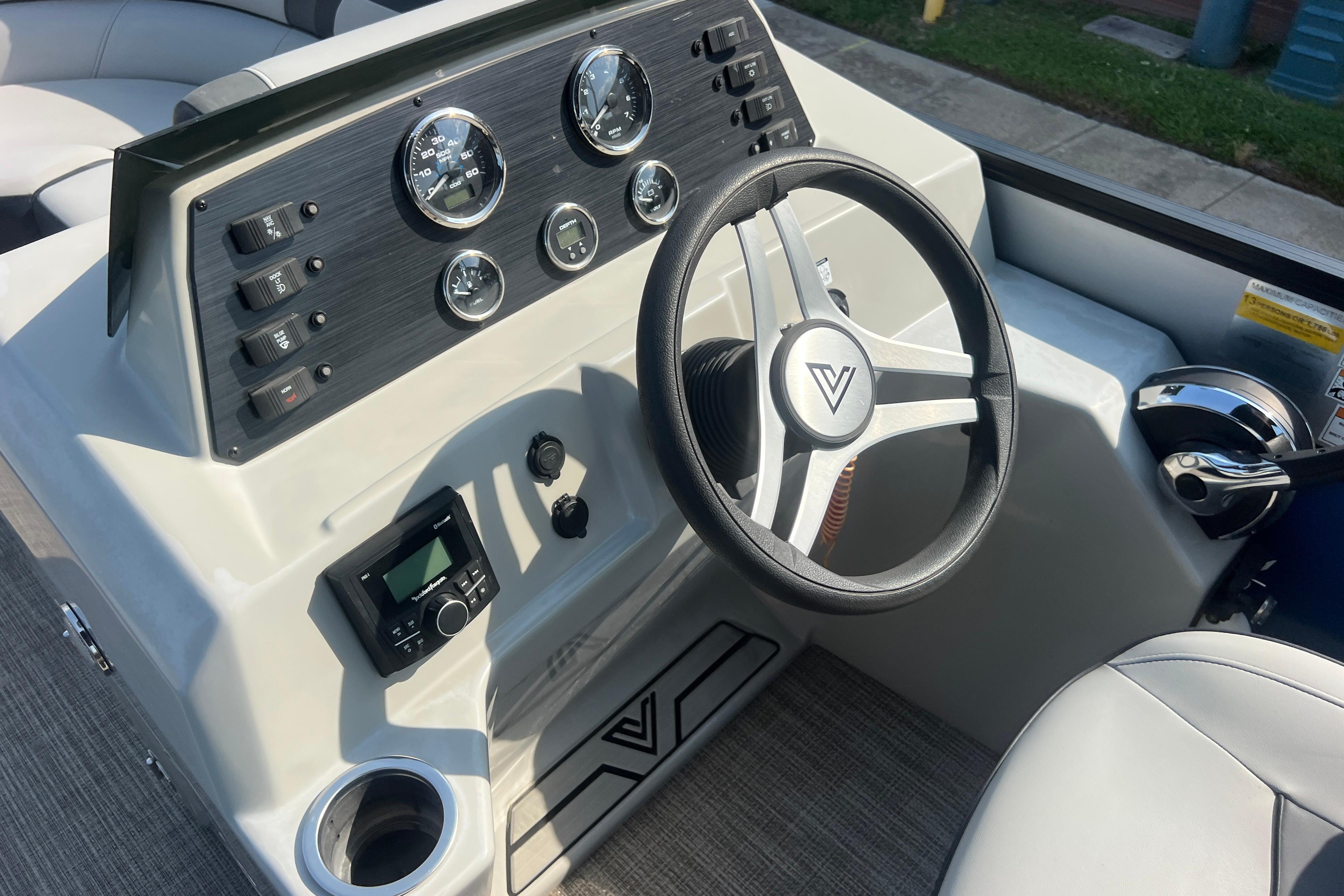 2022 Viaggio Lago V-U 22 boat dashboard with steering wheel and control panel.