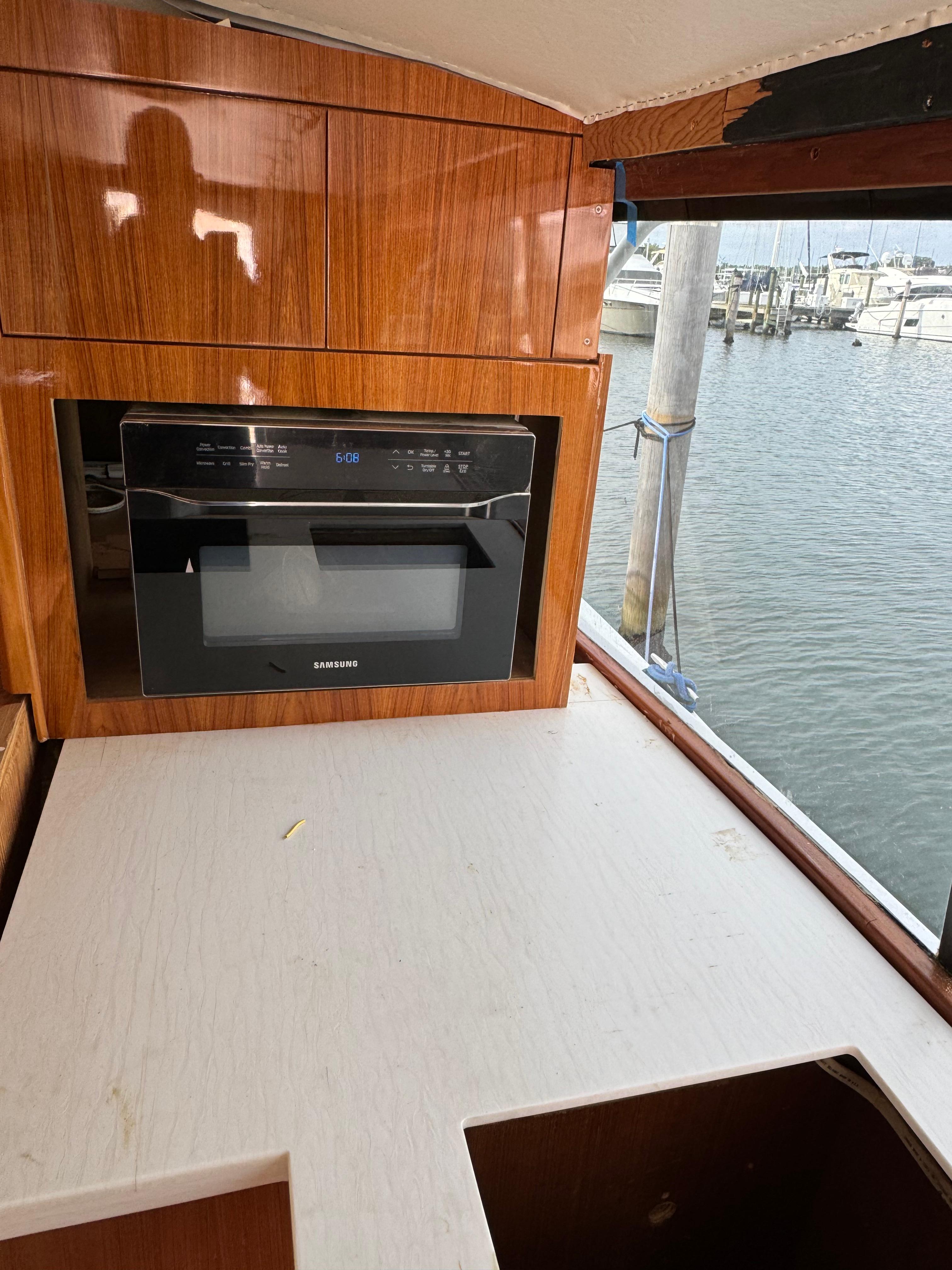 1997 Ocean Yachts 40 Super Sport kitchen area with microwave and marina view.