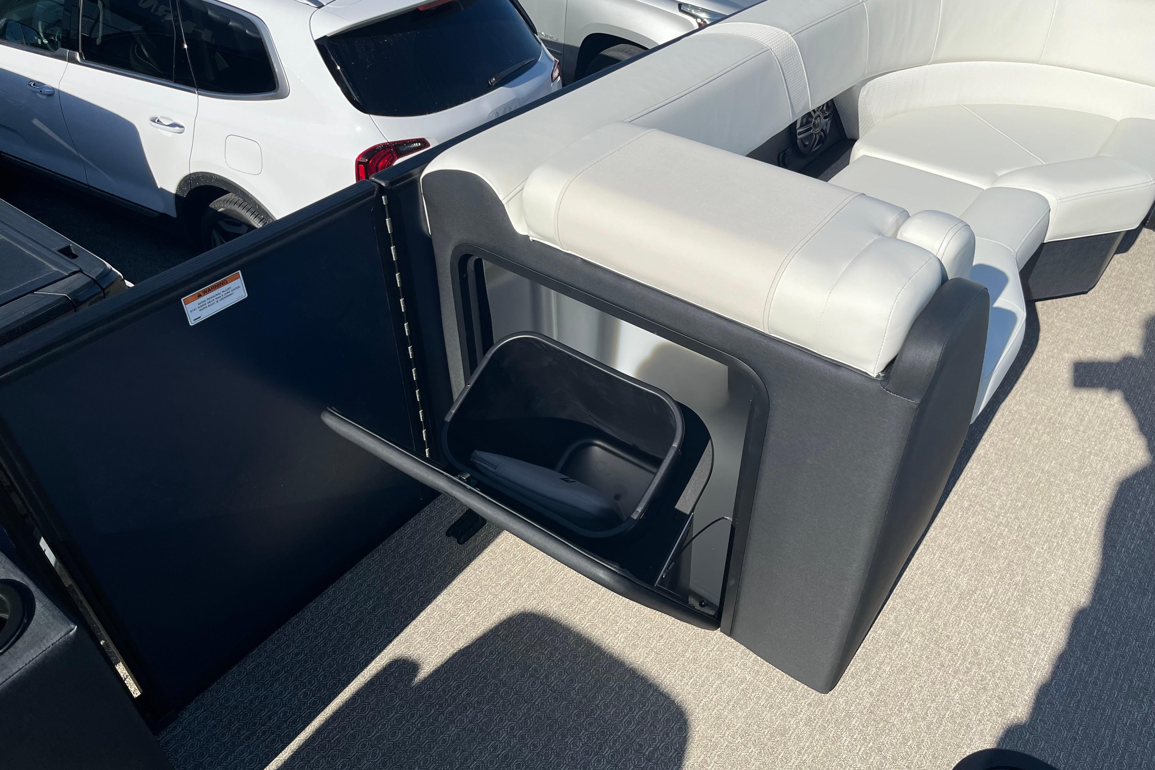 Luxury seating on 2026 Evotti 523CS boat with integrated storage compartment.