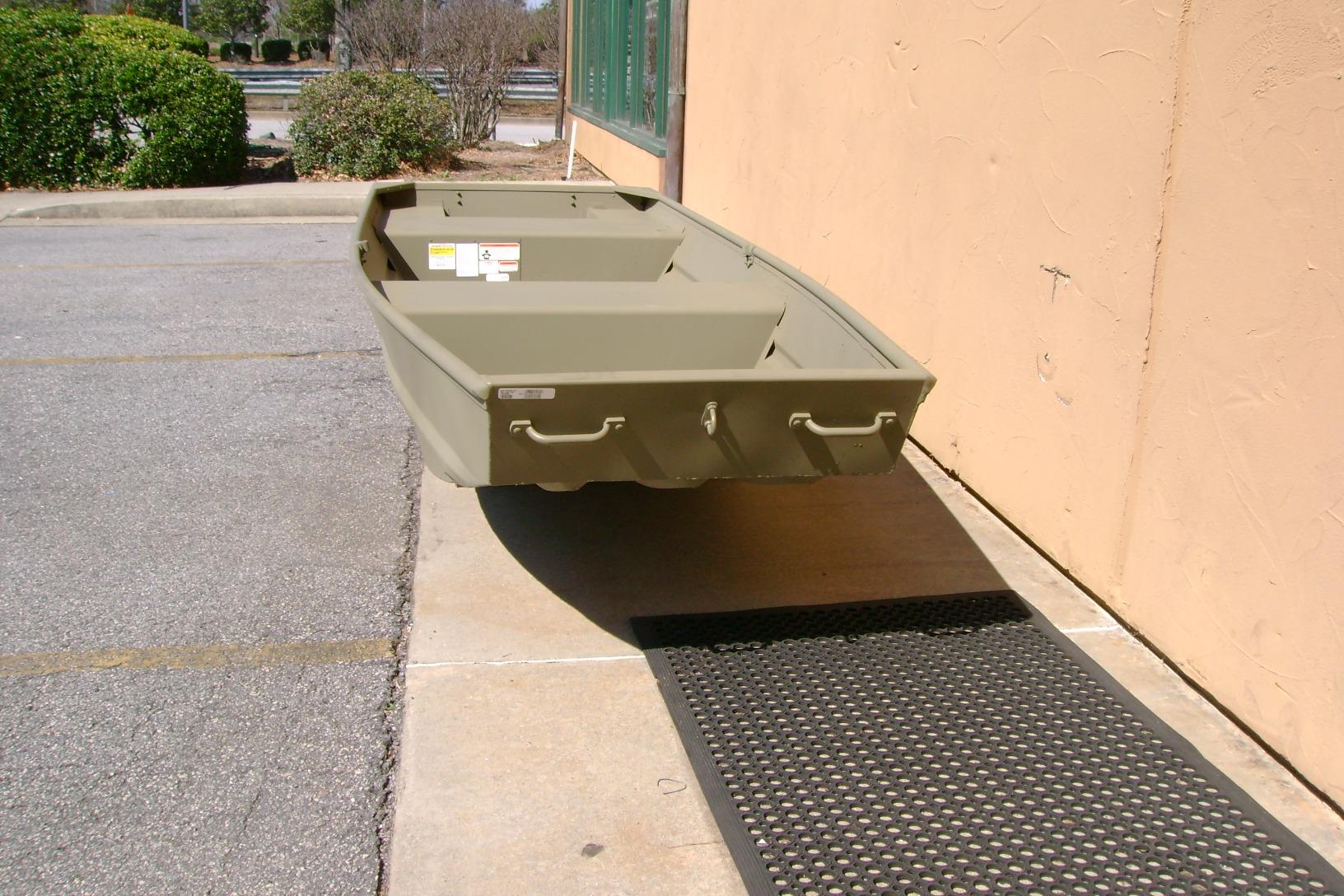 2026 Tracker Grizzly 14 Jon boat in outdoor setting, showcasing its sturdy design.