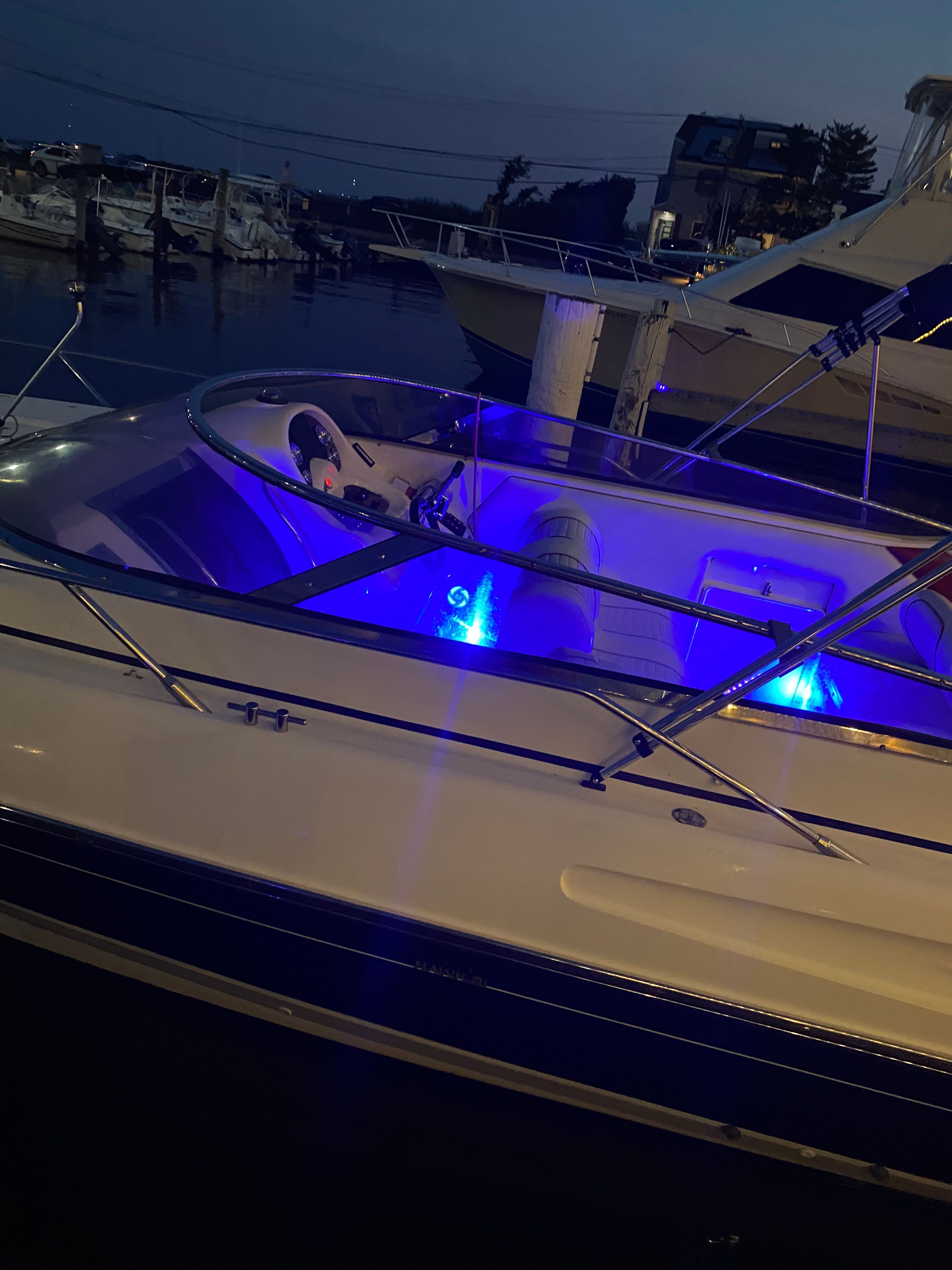 Sunseeker Hawk 31 boat with blue lighting in harbor, 1994 model.