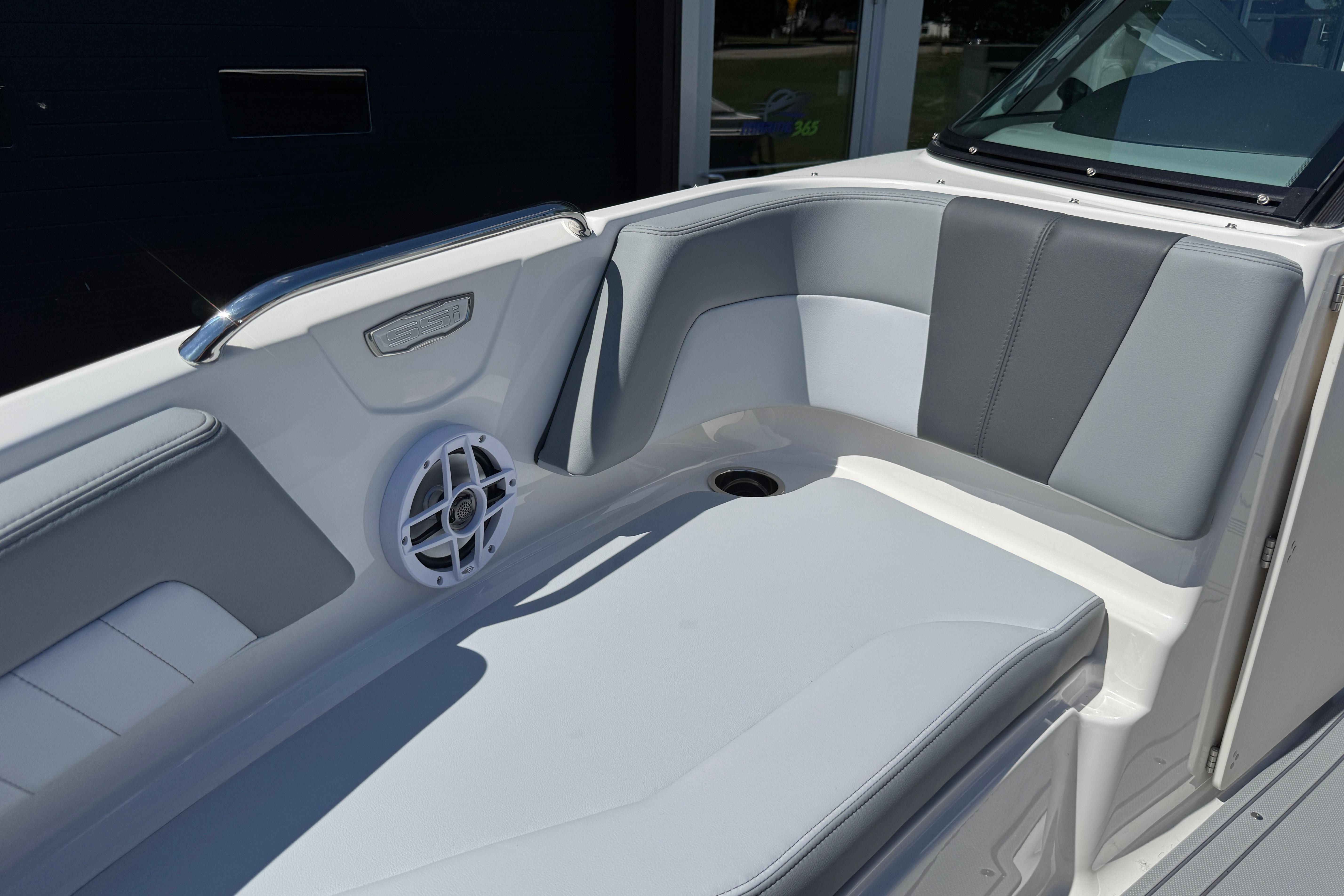 2026 Chaparral 21 SSi boat interior with gray seating and speaker detail.