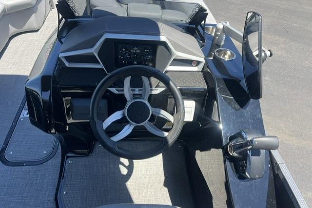 2024 Manitou 25 LX SRW boat dashboard with modern steering wheel and controls.