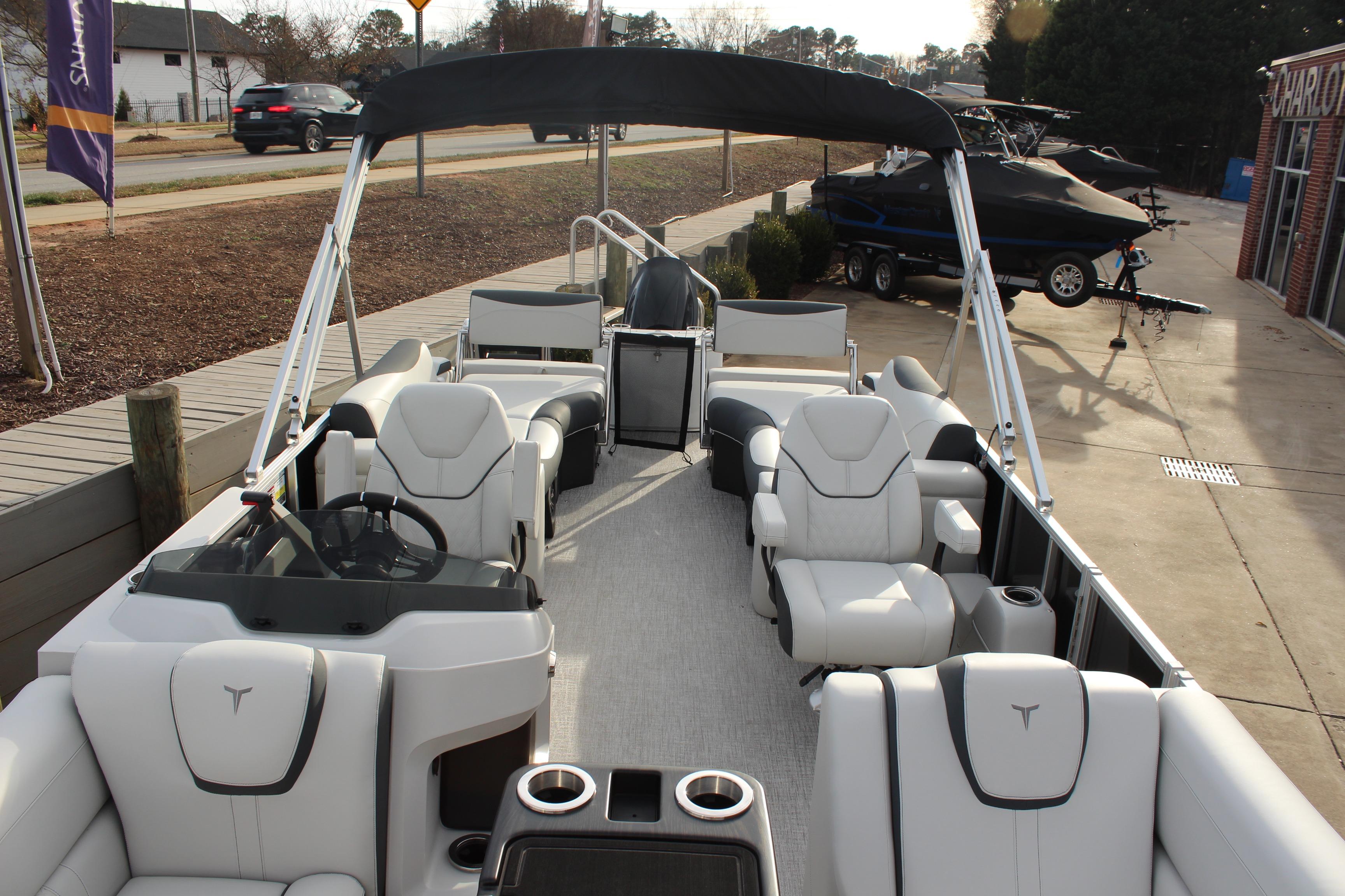 2026 Tahoe Pontoon LTZ boat with luxurious seating and sleek design, docked outdoors.