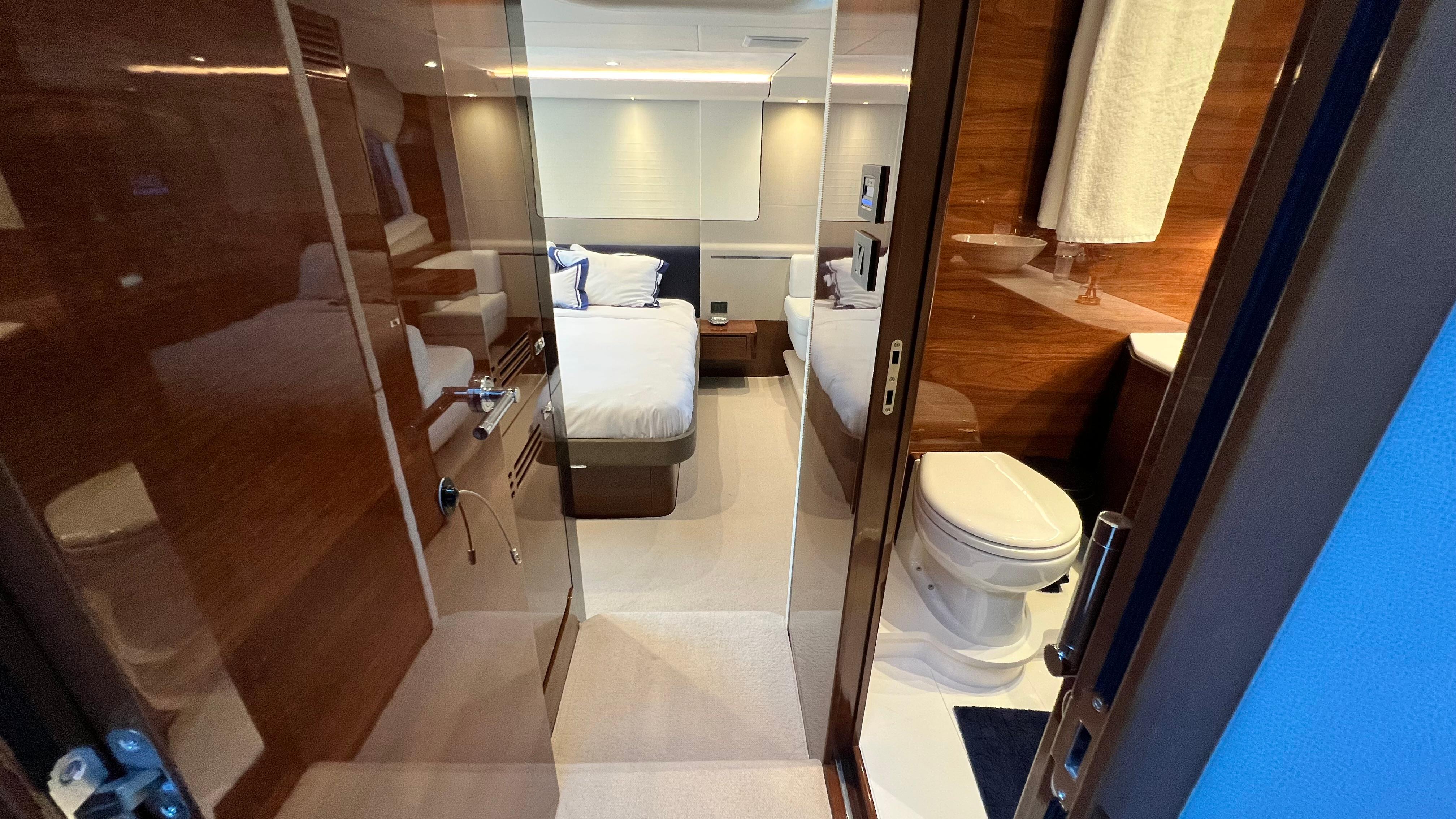 Luxurious interior of 2019 Princess F62 yacht featuring bedroom and bathroom.