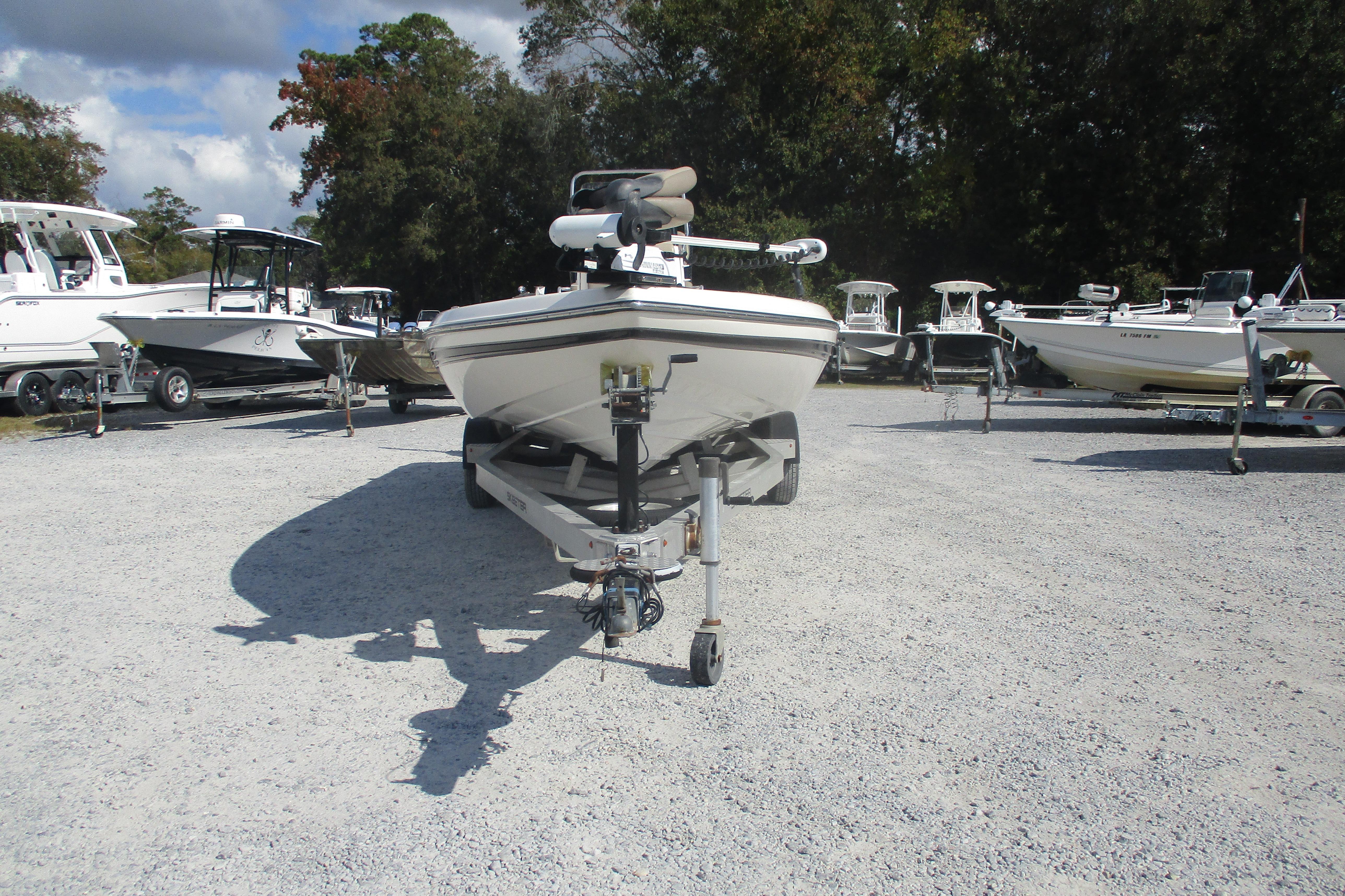 2014 Skeeter SX240 boat on trailer in outdoor lot with other boats.
