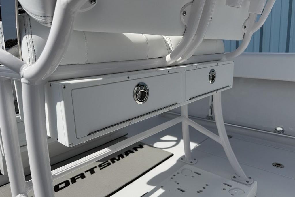 2026 Sportsman Open 252 Center Console boat interior with storage drawers and seating.
