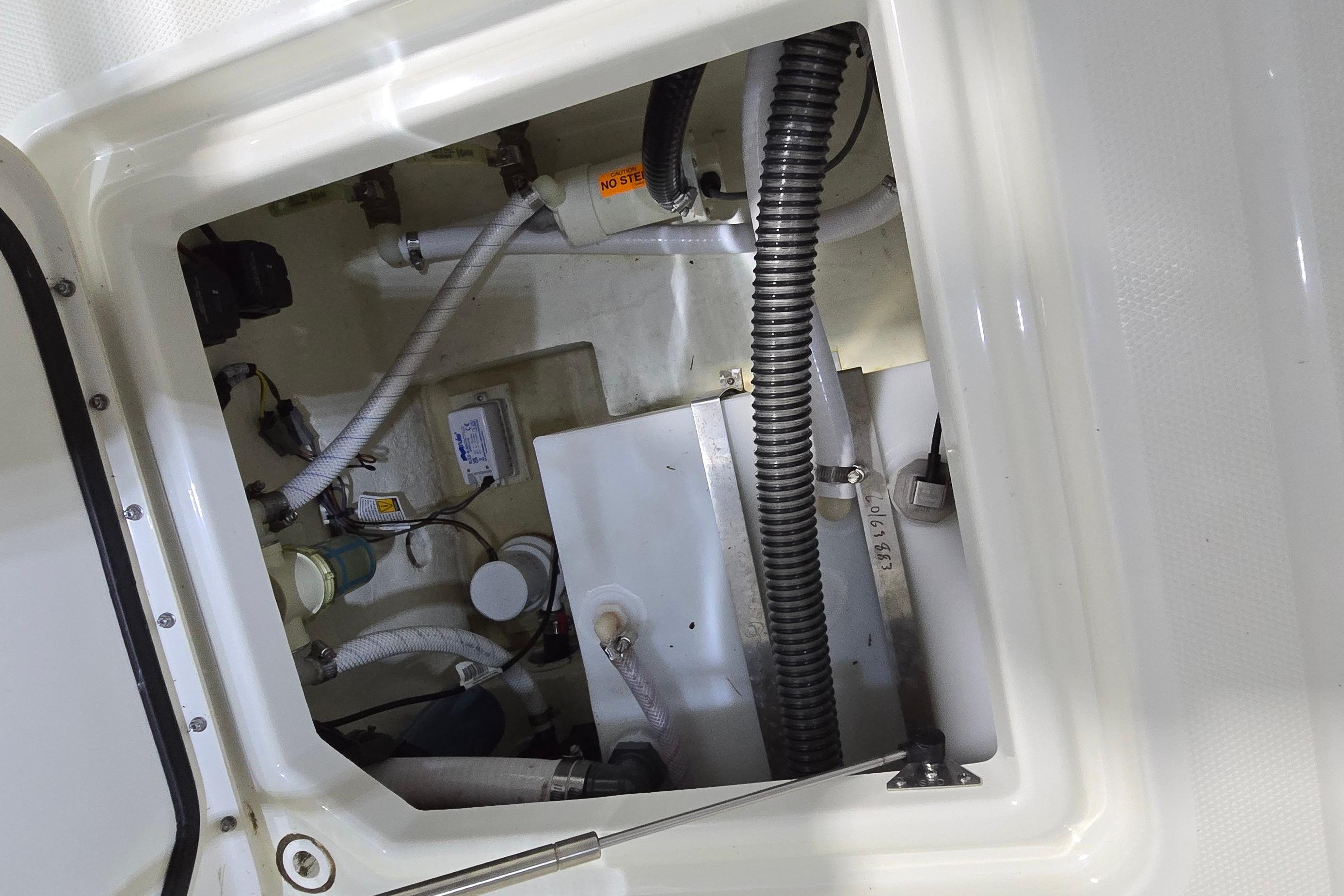 2024 WorldCat 280 CC-X boat interior compartment with wiring and plumbing details.