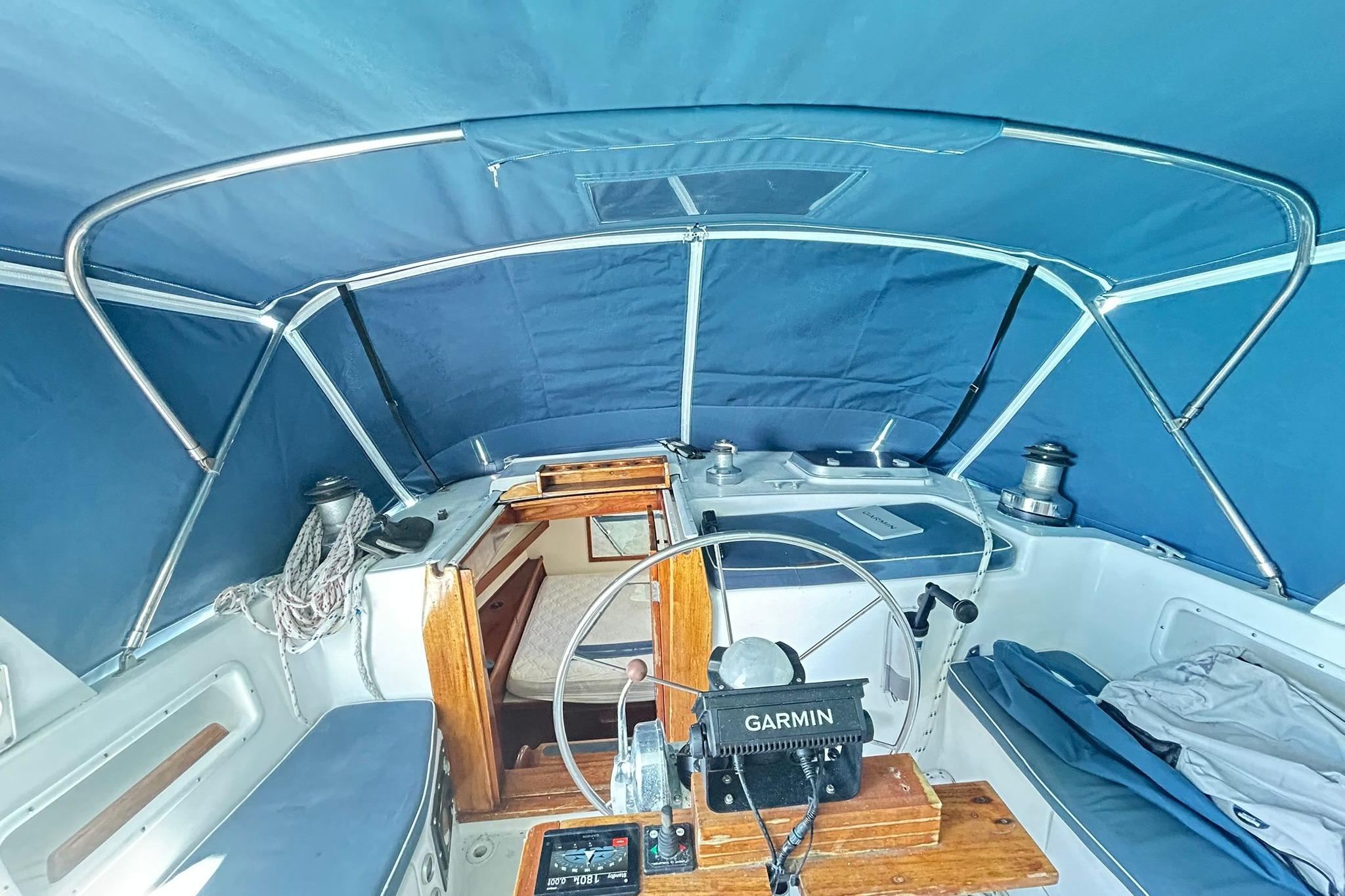 1987 Gulfstar CSY 50 Pilot House cockpit with blue canopy and Garmin navigation system.