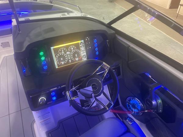 2025 Chaparral 267 SSX boat dashboard with illuminated controls and modern steering wheel.