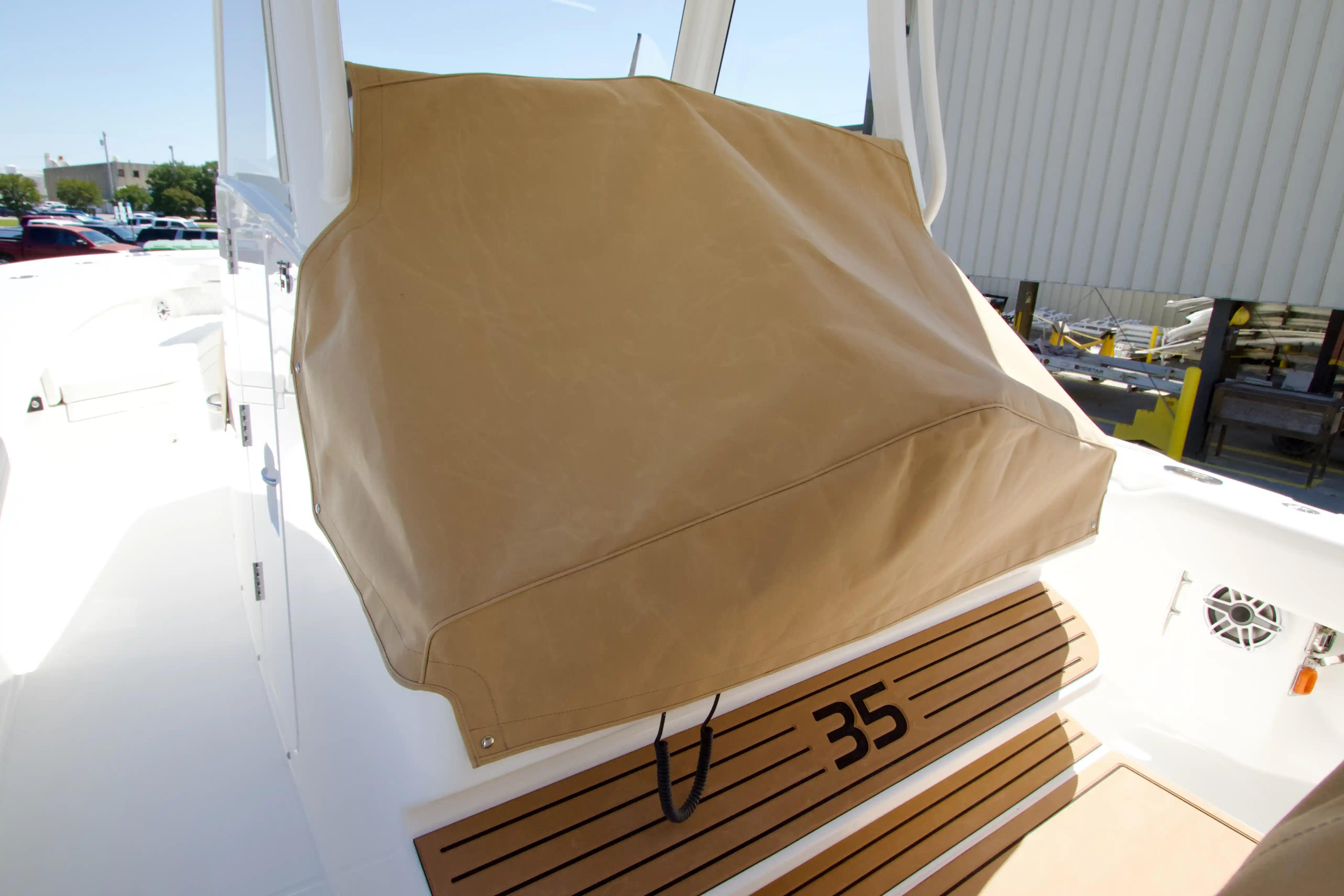2027 Regulator 35 boat with tan cover on deck, showcasing sleek design.