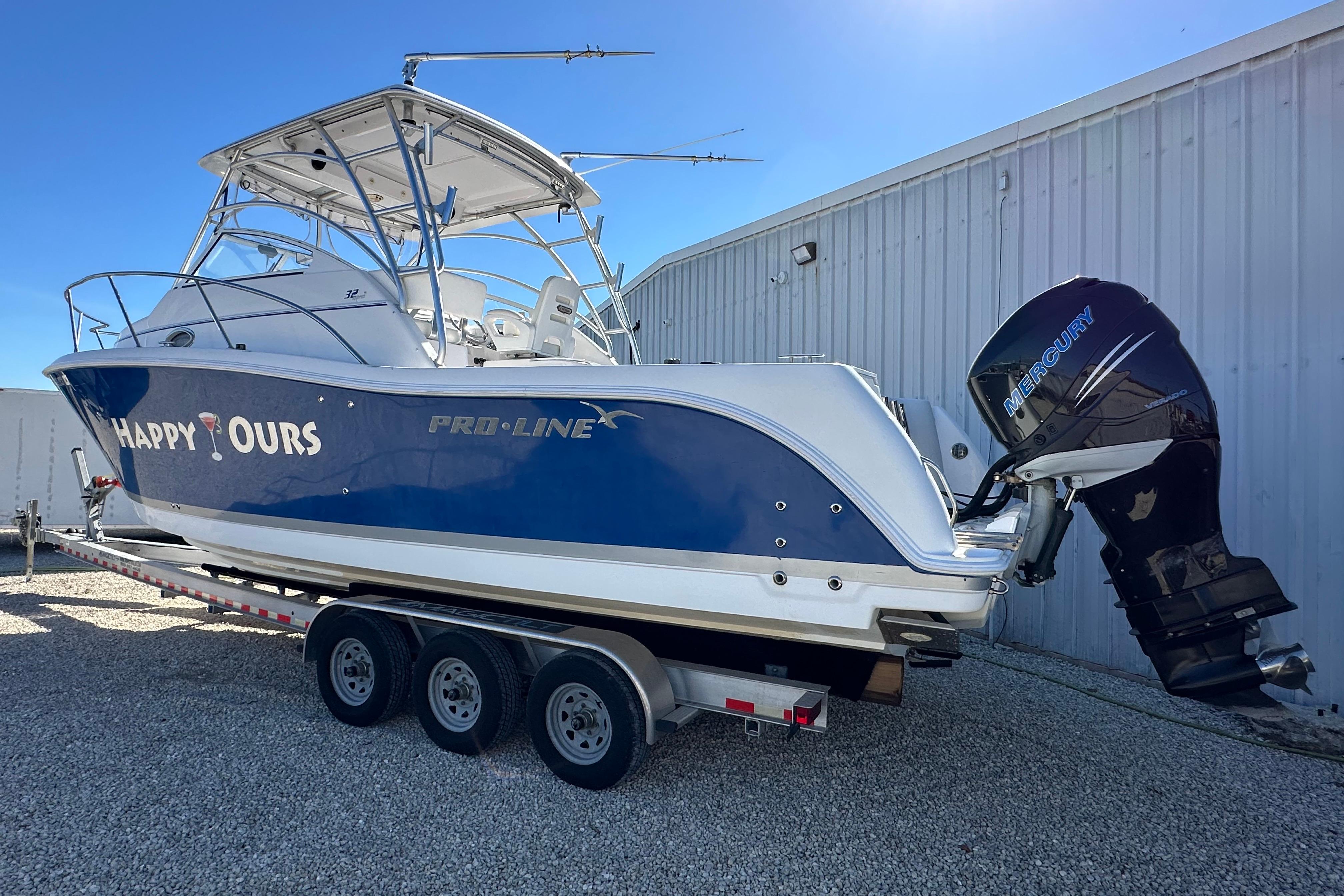 2006 Pro-Line 32 Express boat on trailer with Mercury outboard motor.