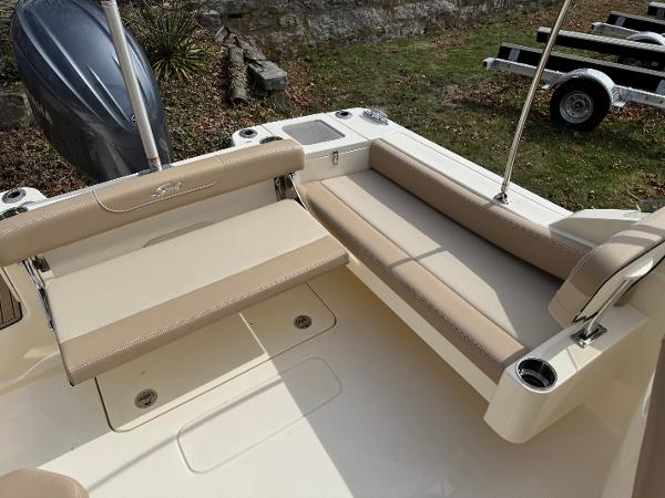2025 Scout 215 Dorado boat interior with beige seating and cup holders.