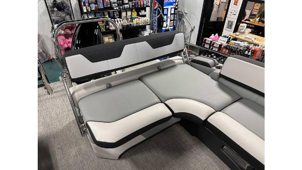 2025 Tahoe Pontoon Cascade Cruise Rear Bench, gray and black seating in showroom.