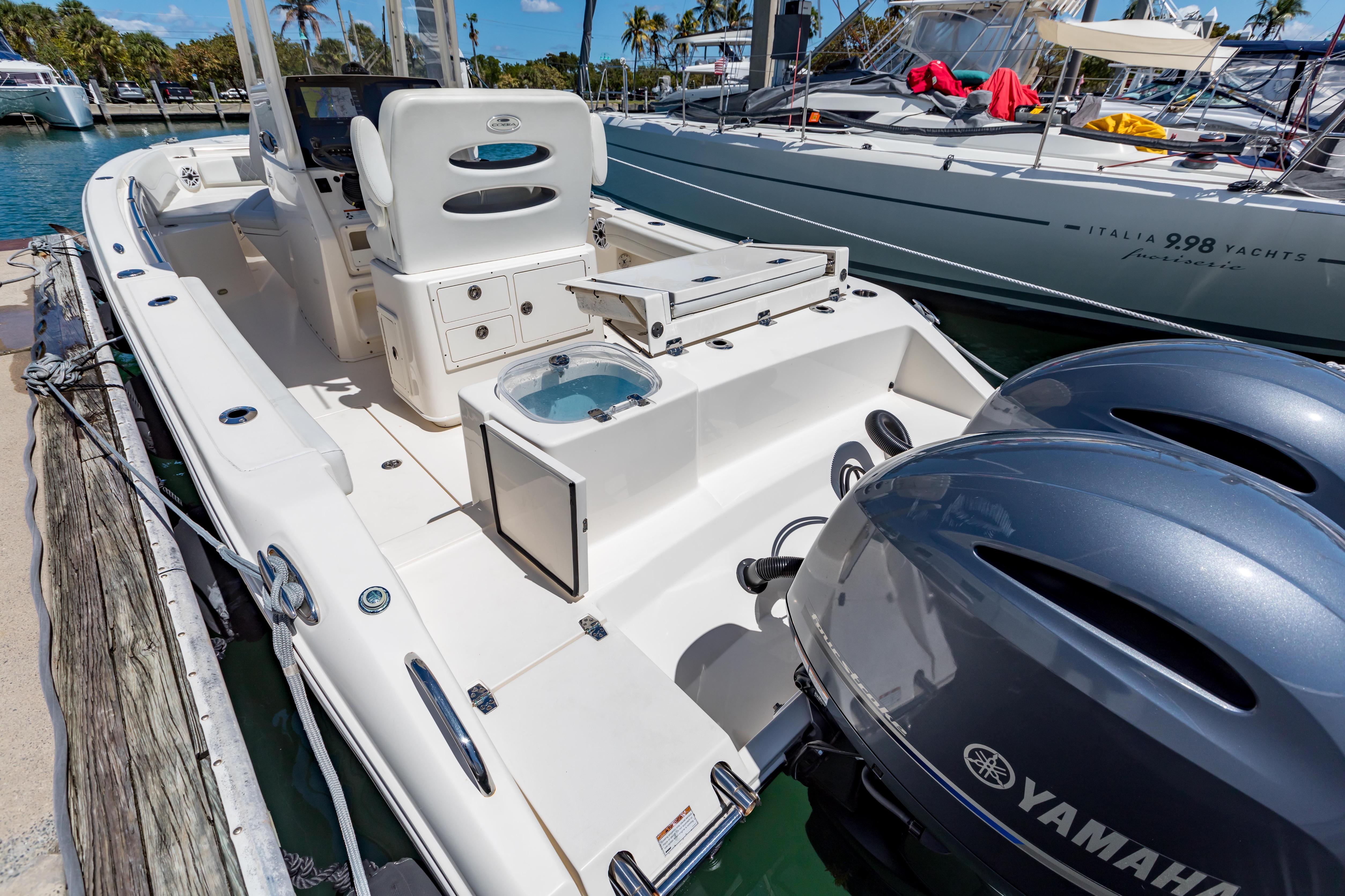 2023 Cobia 240 Center Console boat docked with Yamaha engines.