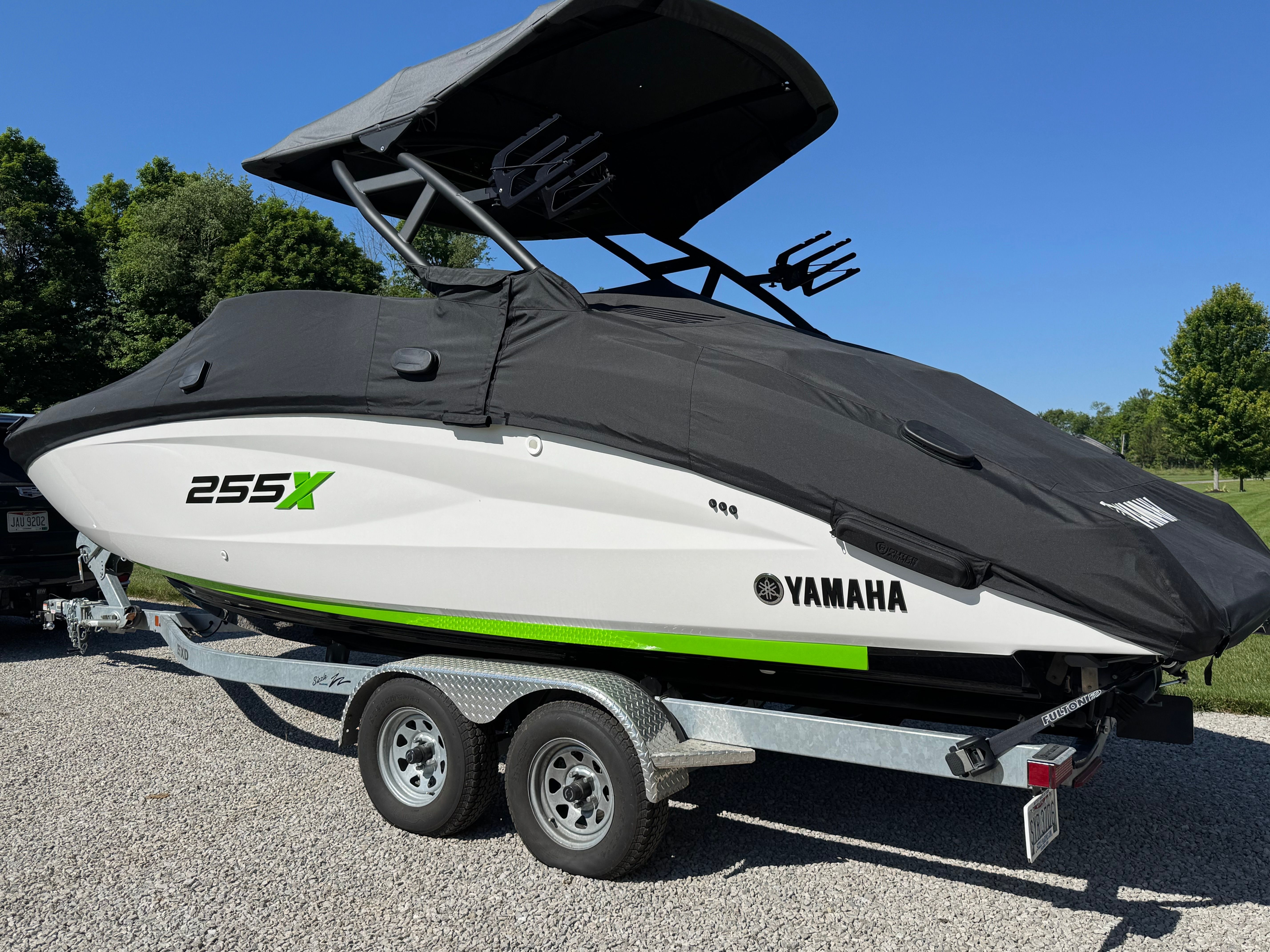 Yamaha 255XD boat from 2022 on a trailer, with black cover and green accent.